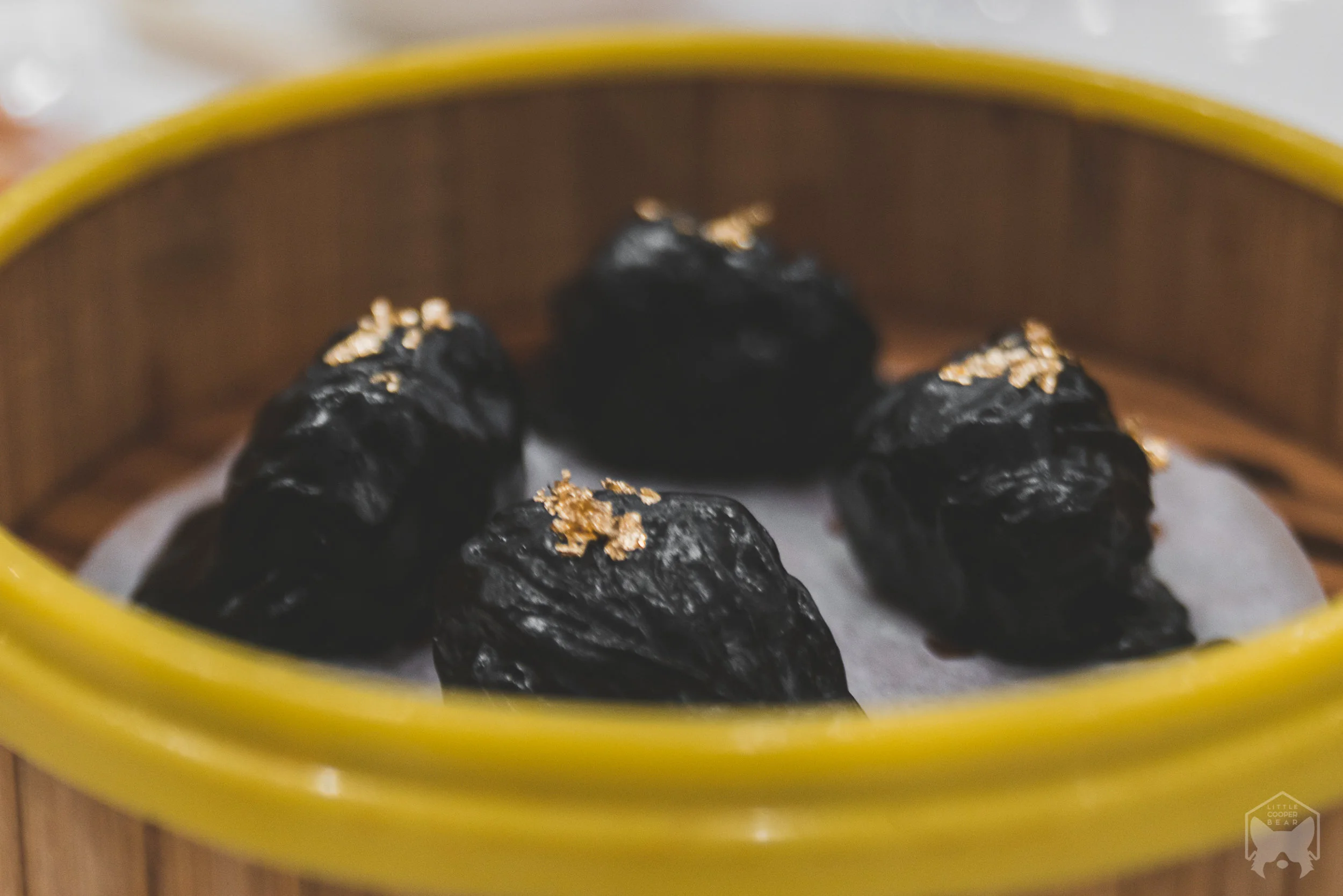 Squid ink har gao with gold flakes