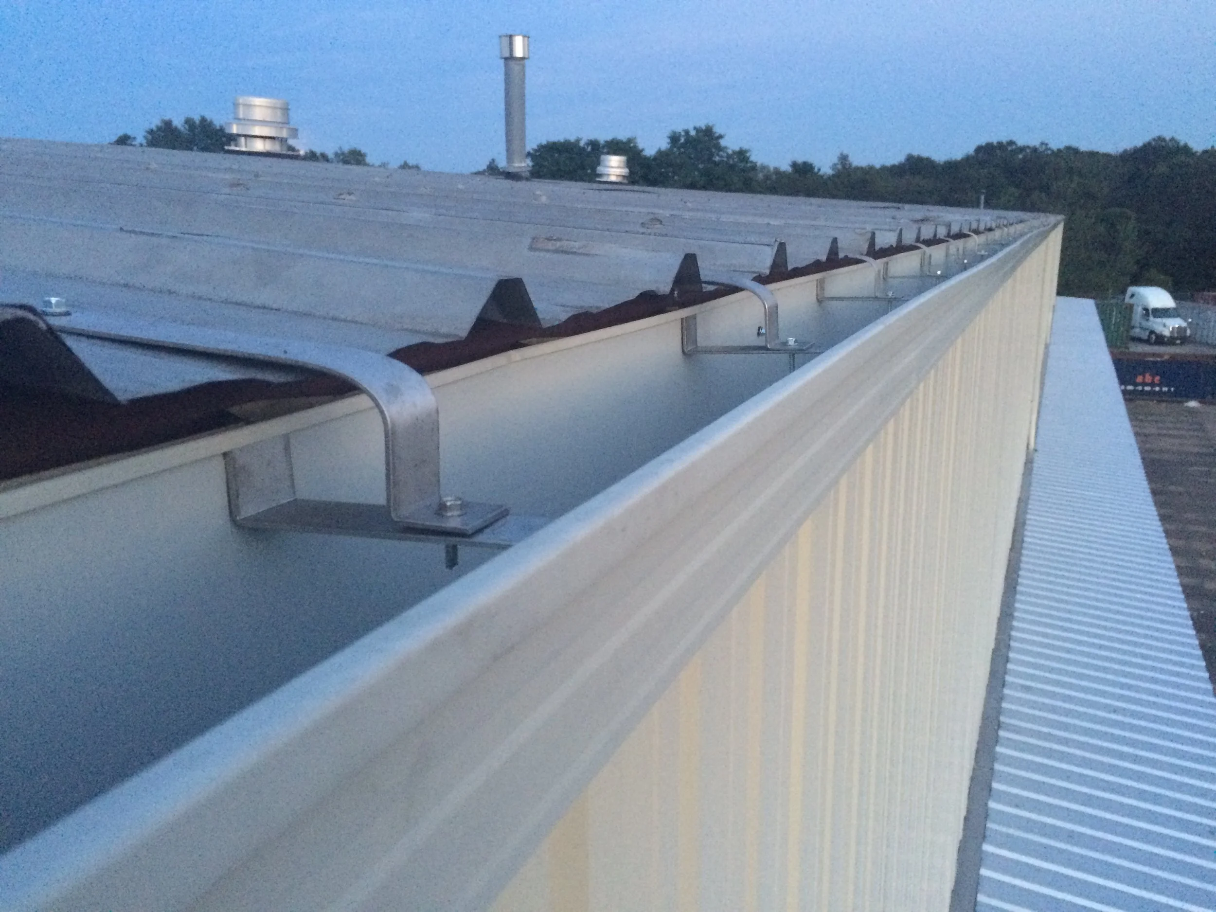 Industrial Seamless 7in box gutter on roof hangers.JPG