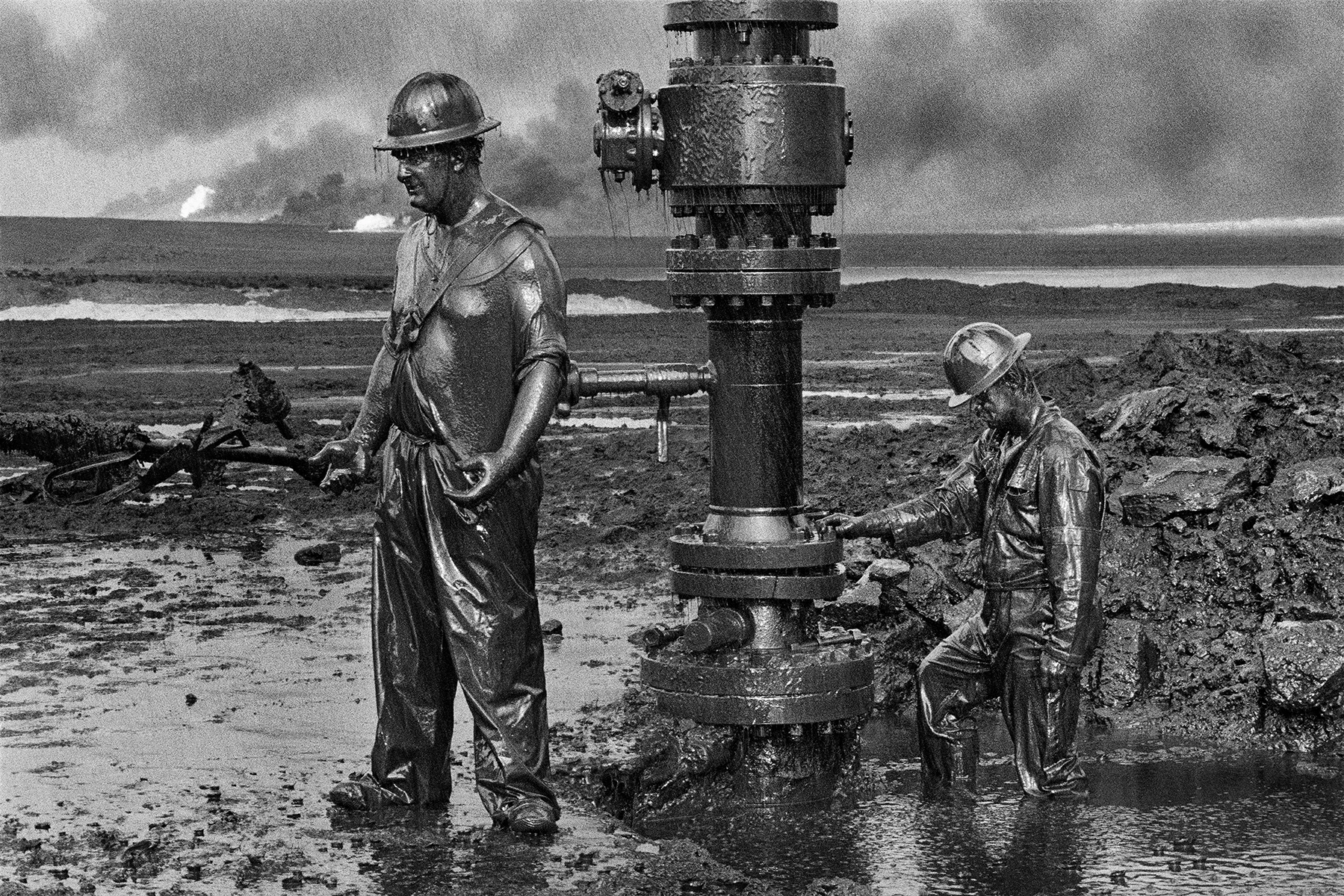 Sebastião Salgado, kuwait worker standing in oil.jpg