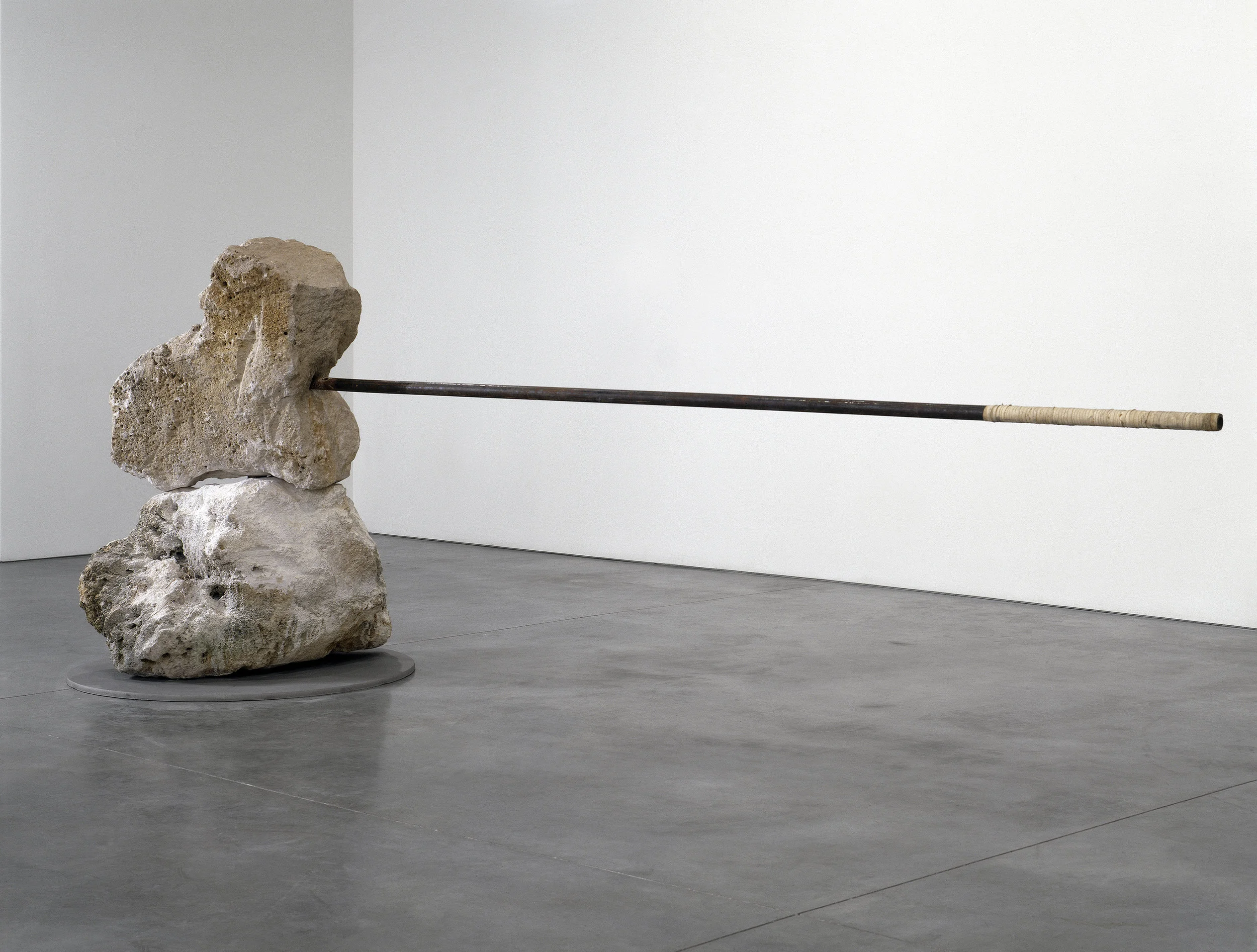 Janine Antoni, And , 1996-99. Two 800 lb. limestone boulders, stainless steel rod and base © Janine Antoni; Courtesy of the artist and Luhring Augustine, New York