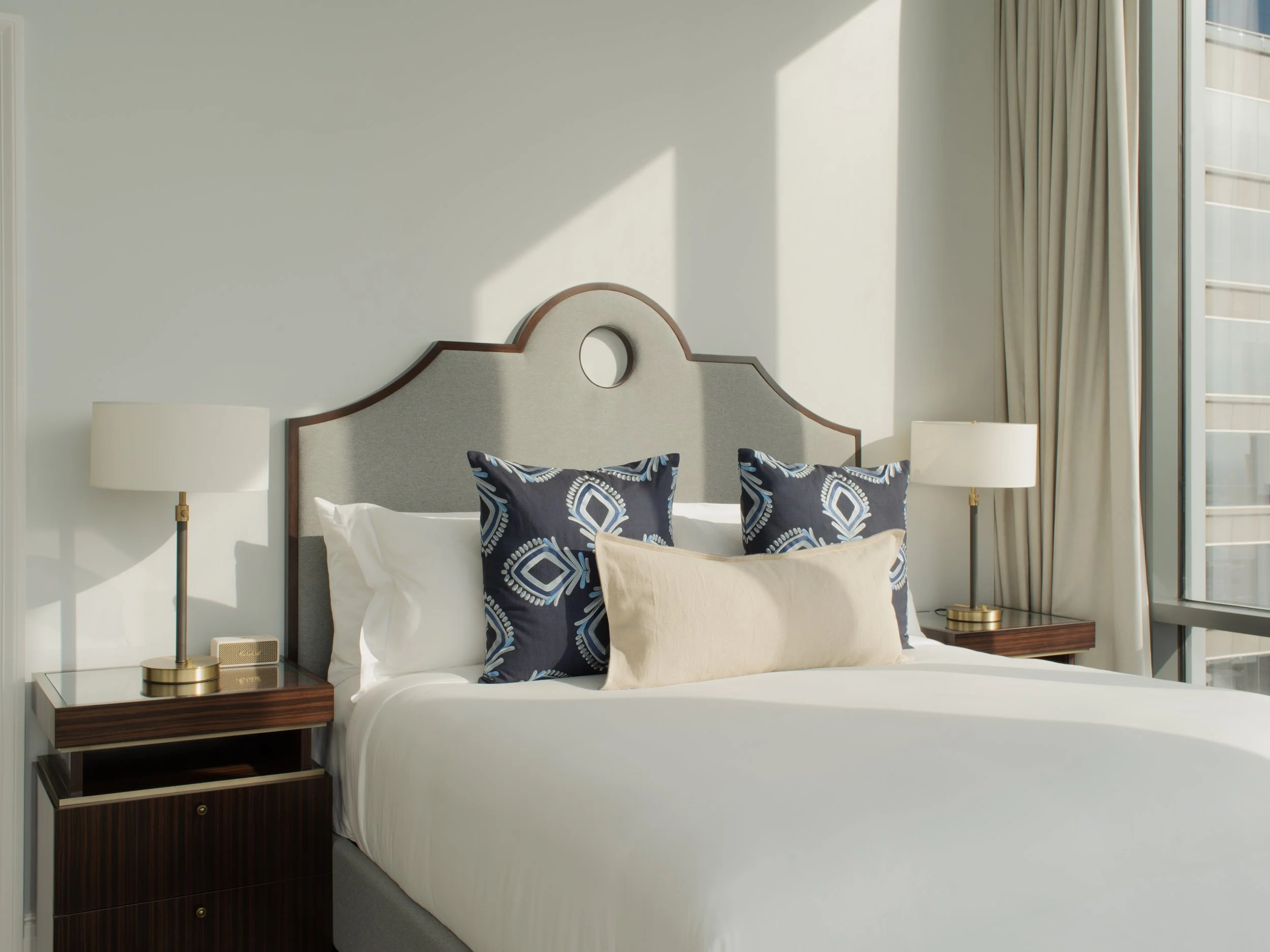 Guest room at Hôtel Swexan with floor-to-ceiling windows and Dallas skyline views