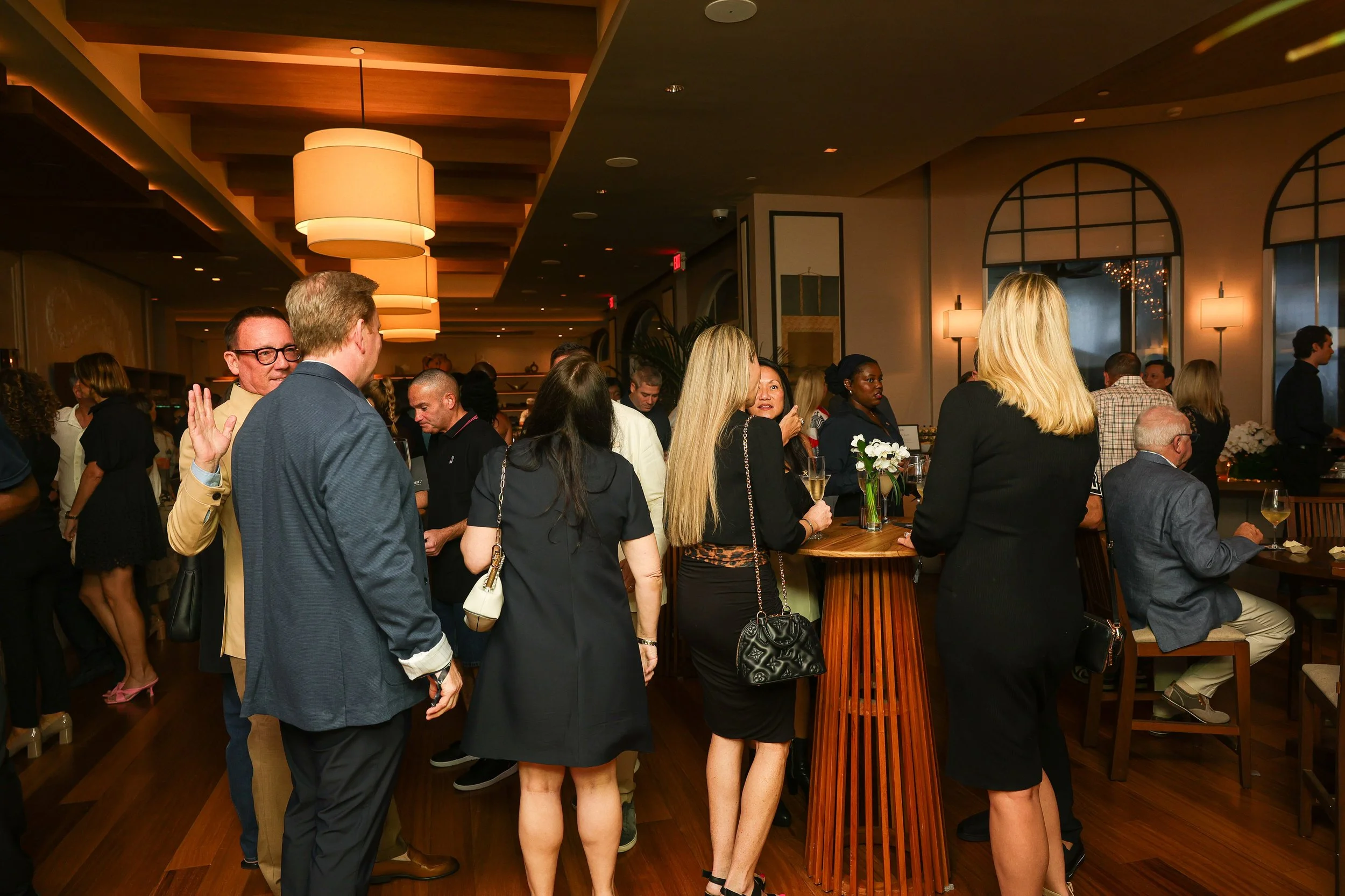 Guests eating and drinking at Taste of Nobu Manalapan, the first-anniversary party at Nobu Manalapan in Manalapan, Florida