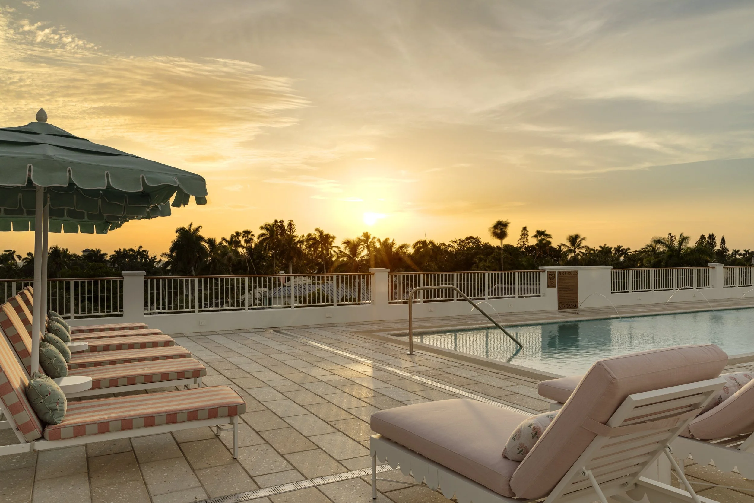 The rooftop pool with cabanas at Olde Naples Hotel overlooking Old Naples