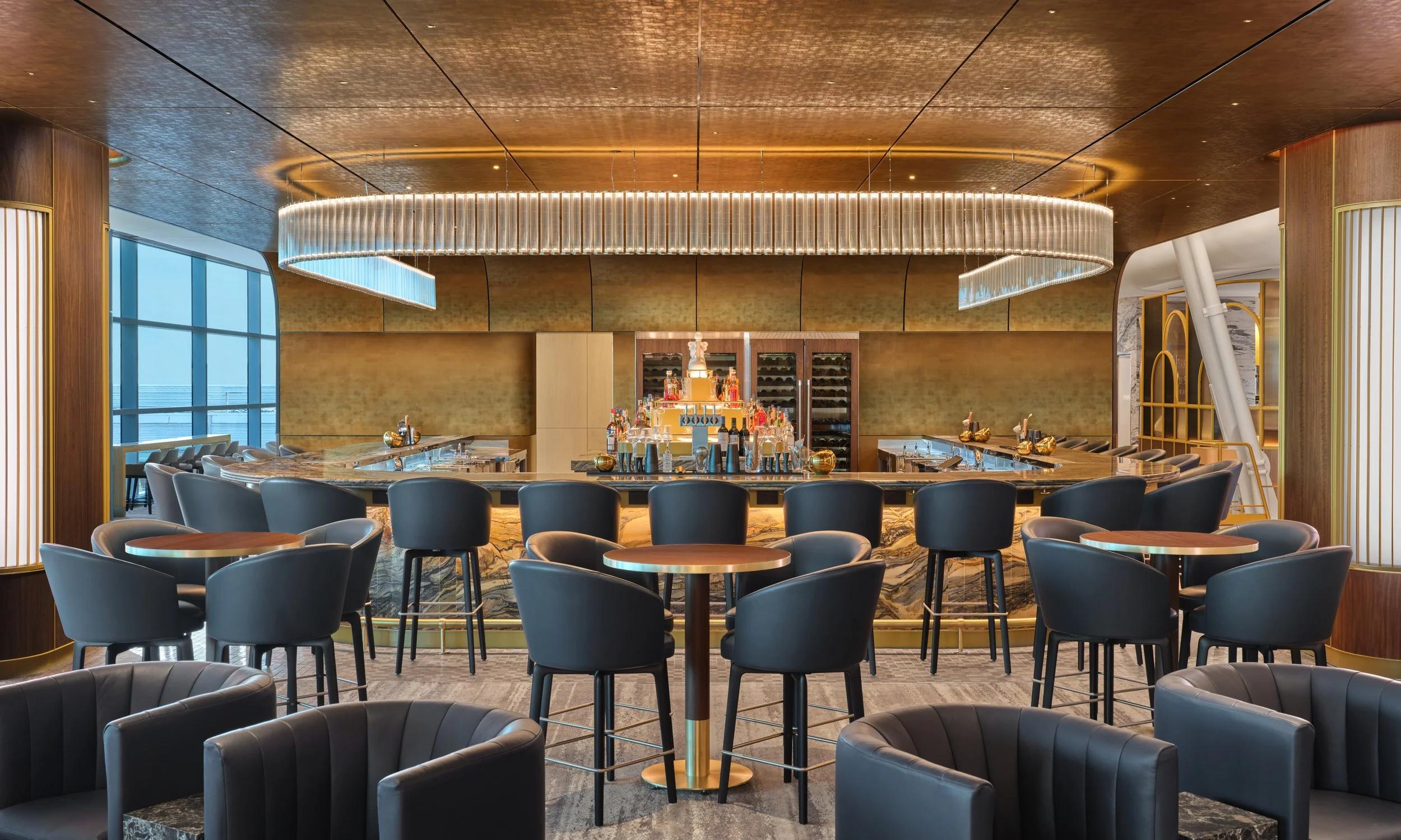 A Delta One Lounge bar with modern seating and a large illuminated chandelier
