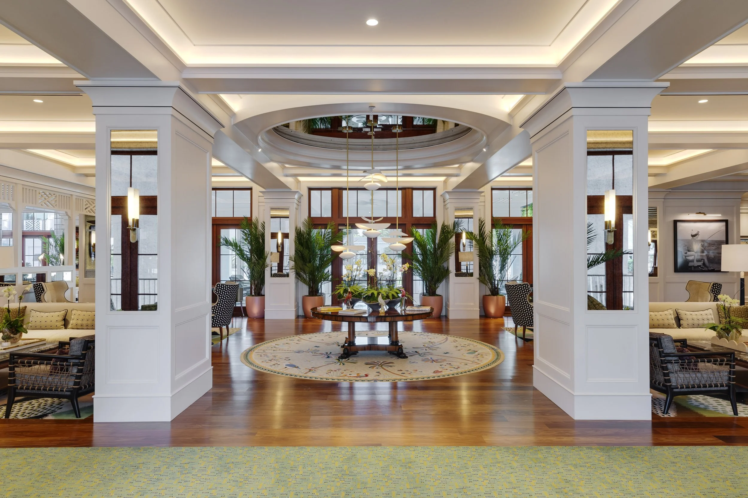 The lobby of Olde Naples Hotel with a mirrored ceiling dome and Old Florida detailing