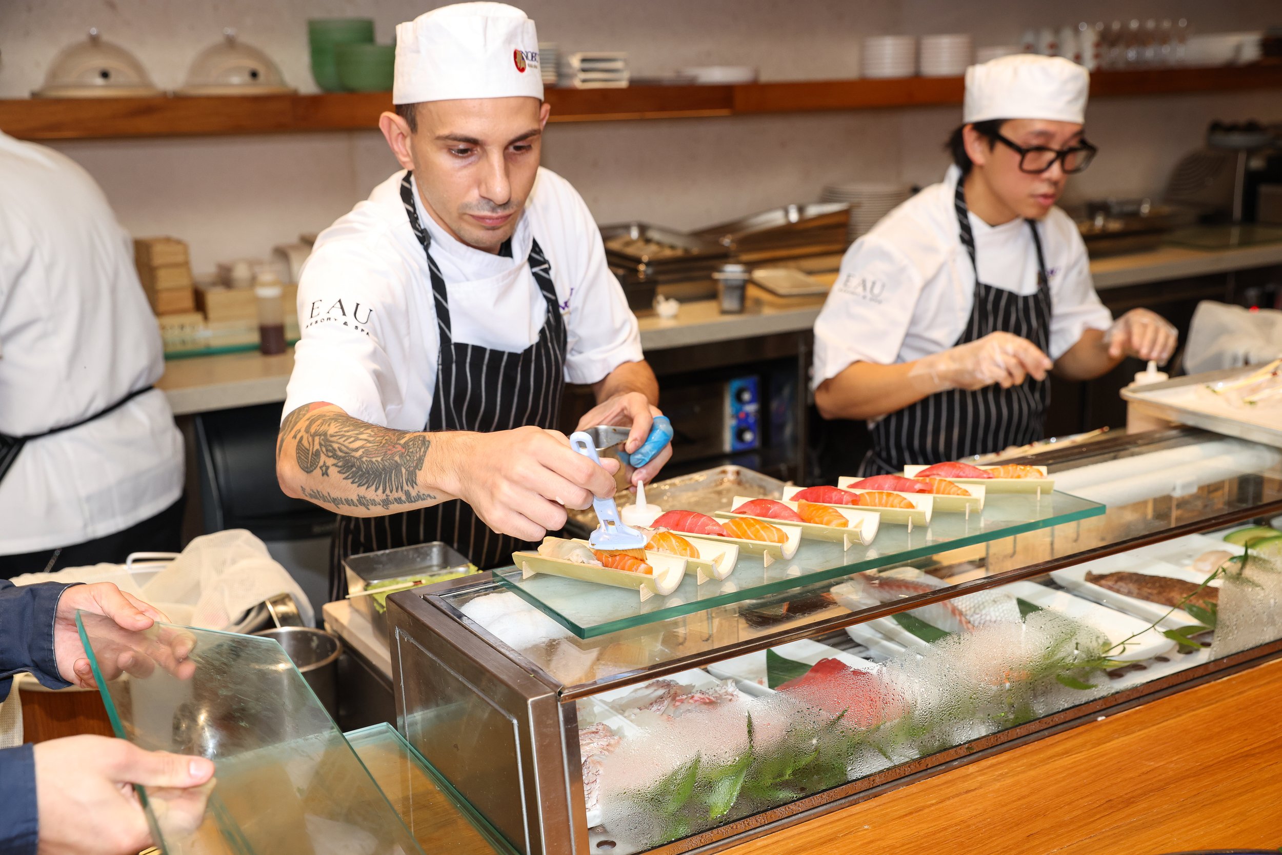 Sushi chefs hand-rolling and plating sushi to order at Taste of Nobu Manalapan