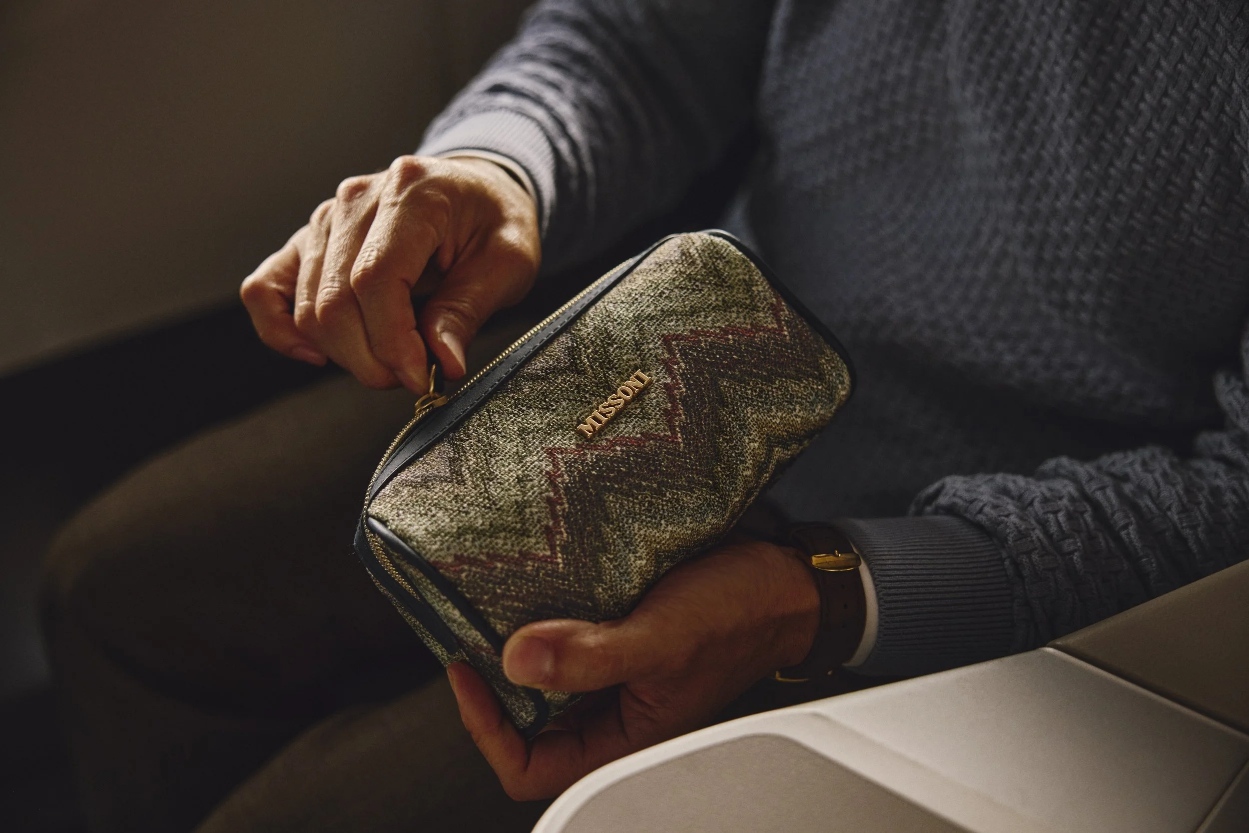 A Missoni amenity kit from the new Delta One collection being opened in the premium cabin