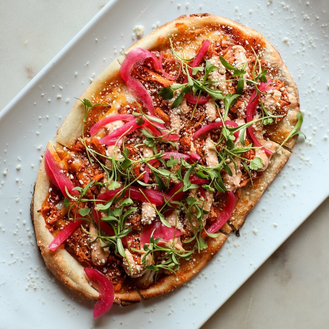 Chili spiced tomato sauce, cheddar jack cheese, shredded chicken breast, chipotle aioli, lime pickled red onions, cotija cheese, and micro cilantro. 
&nbsp;
That&rsquo;s what&rsquo;s on top of our &lsquo;Chicken Tinga Flatbread&rsquo; special this we