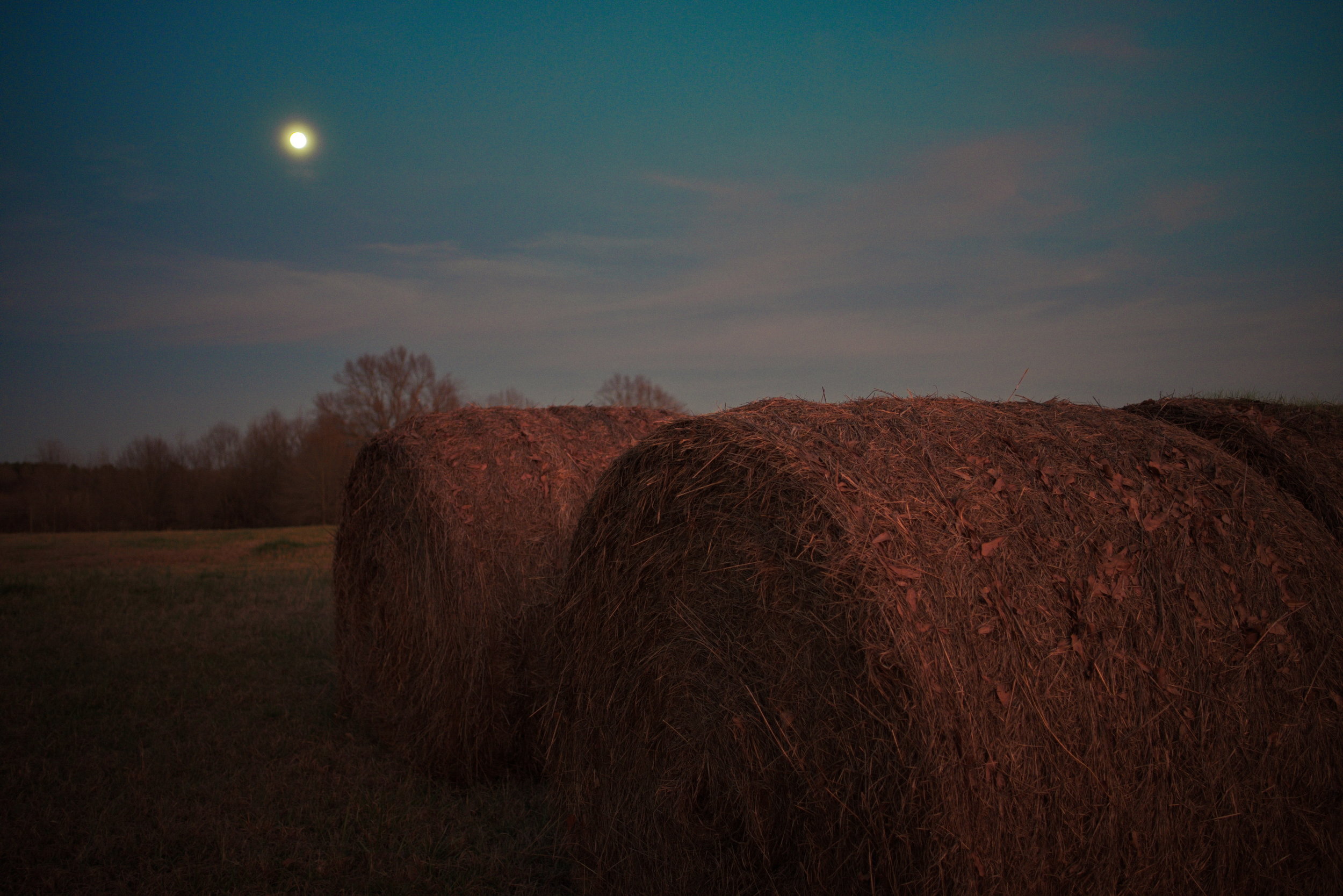  Full moon rising over hay bales along Highway 32 just west of U.S. Highway 51 