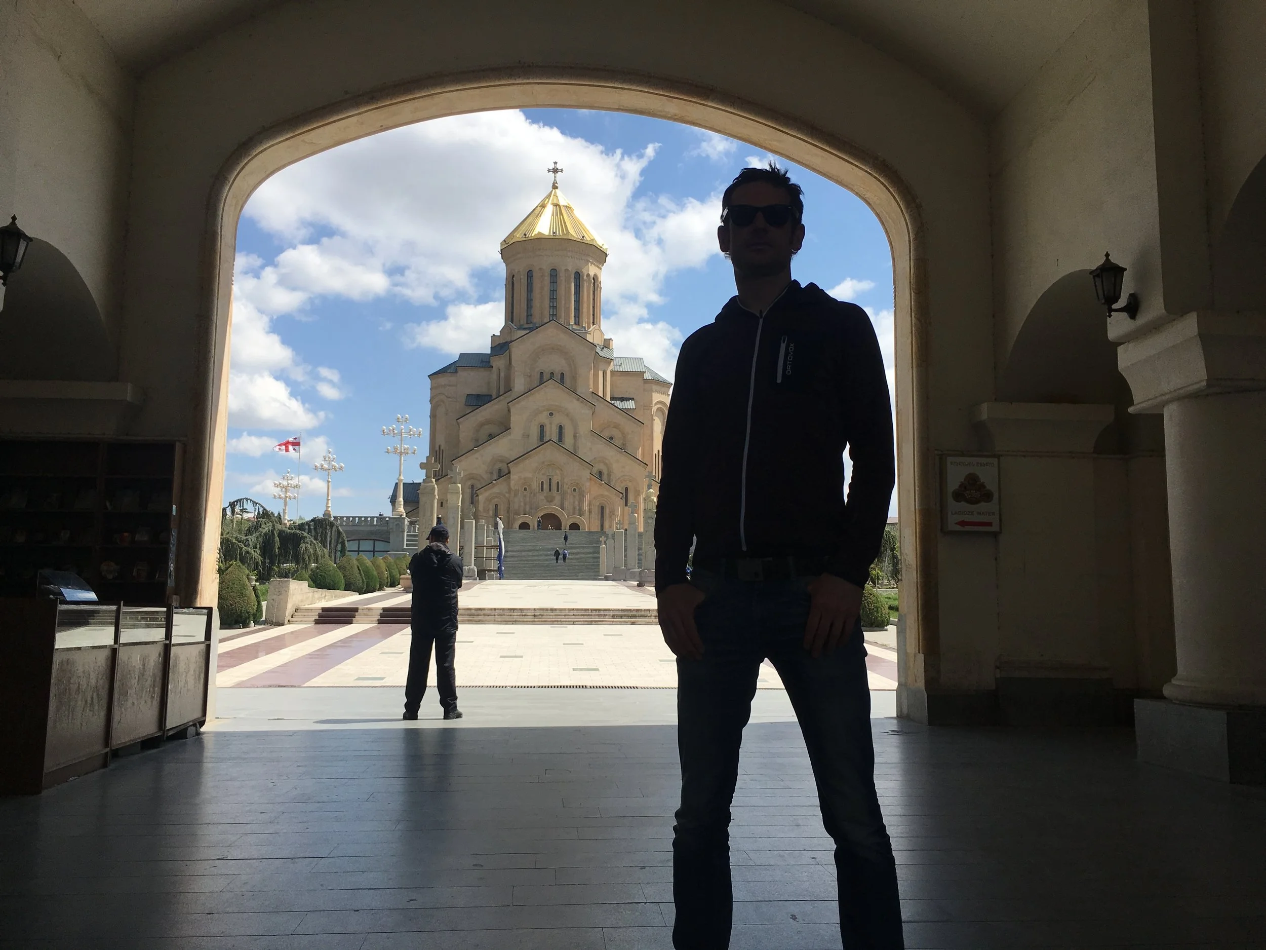 The trinity of the Holy Trinity Cathedral of Tbilisi, a security man and Thies.