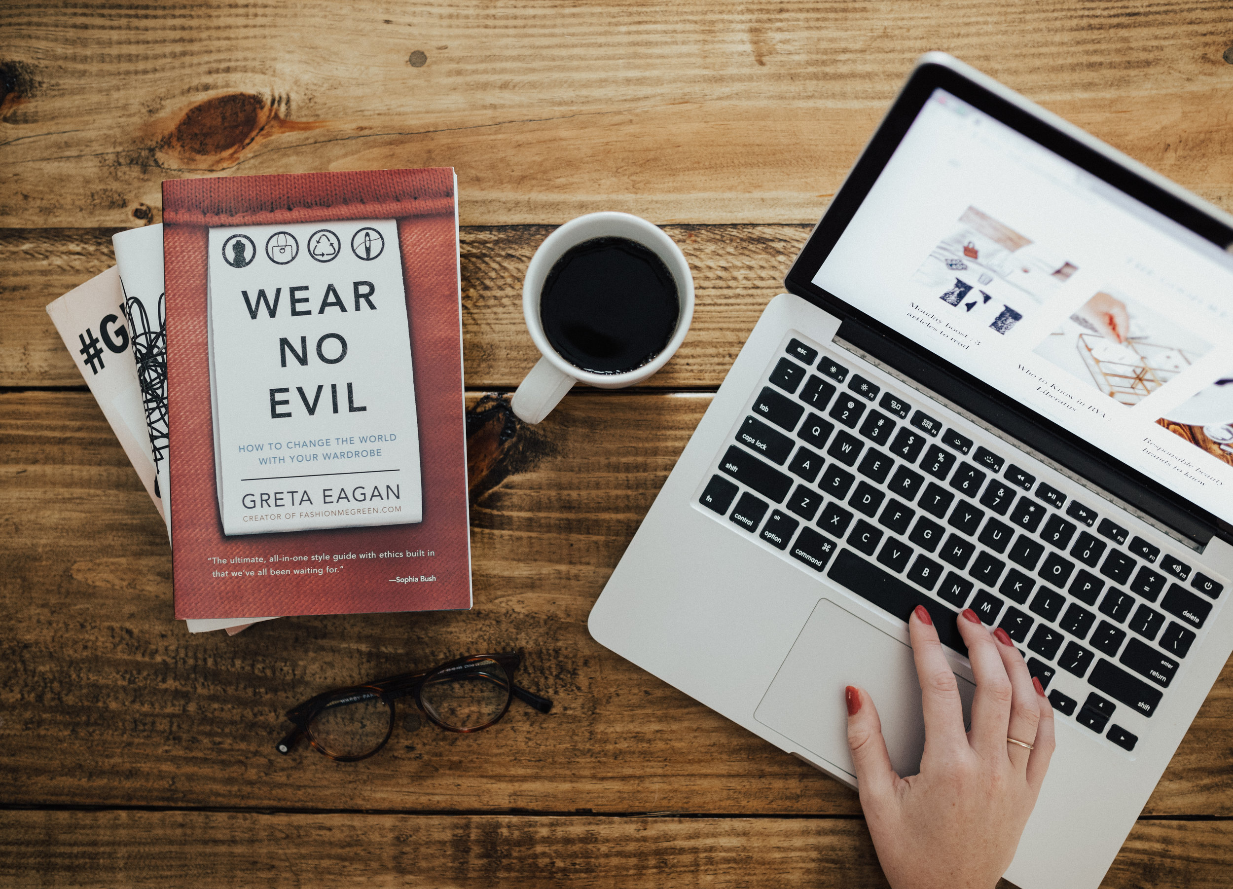 A typical scene of necessary items when writing for The Good Wear. Coffee, glasses, computer and necessary resources to keep learning and providing the facts!
