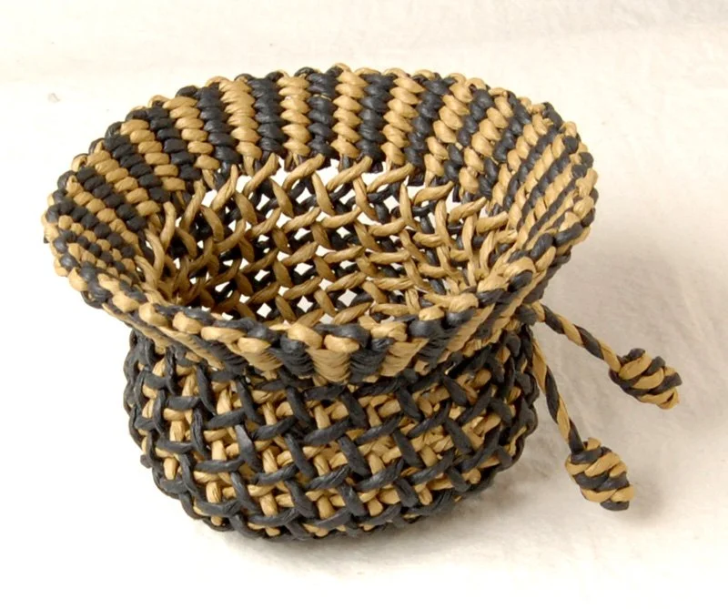 Waffle Basket, 2010. 2-ply, 2-color cords made from paper ribbon. Plain oblique twining (POT) with a full twist between the splittings. 1 of the 12 baskets in my book “How to Make Ply-Split Baskets".