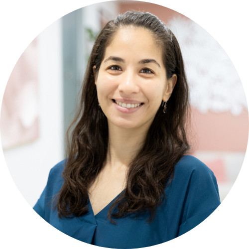 Acupuncture, Chinese Herbal Medicine Practitioner and Certified NET Practitioner at Healing Hands Natural Health Centre, a woman with long dark hair smiling, wearing a blue top, in a professional setting.
