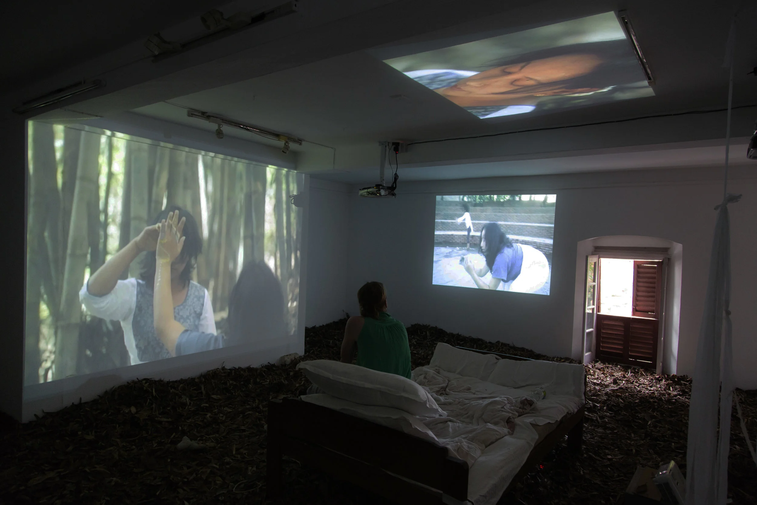 Visitor watches 4-feed video installation of Ma (part 1-4) .
