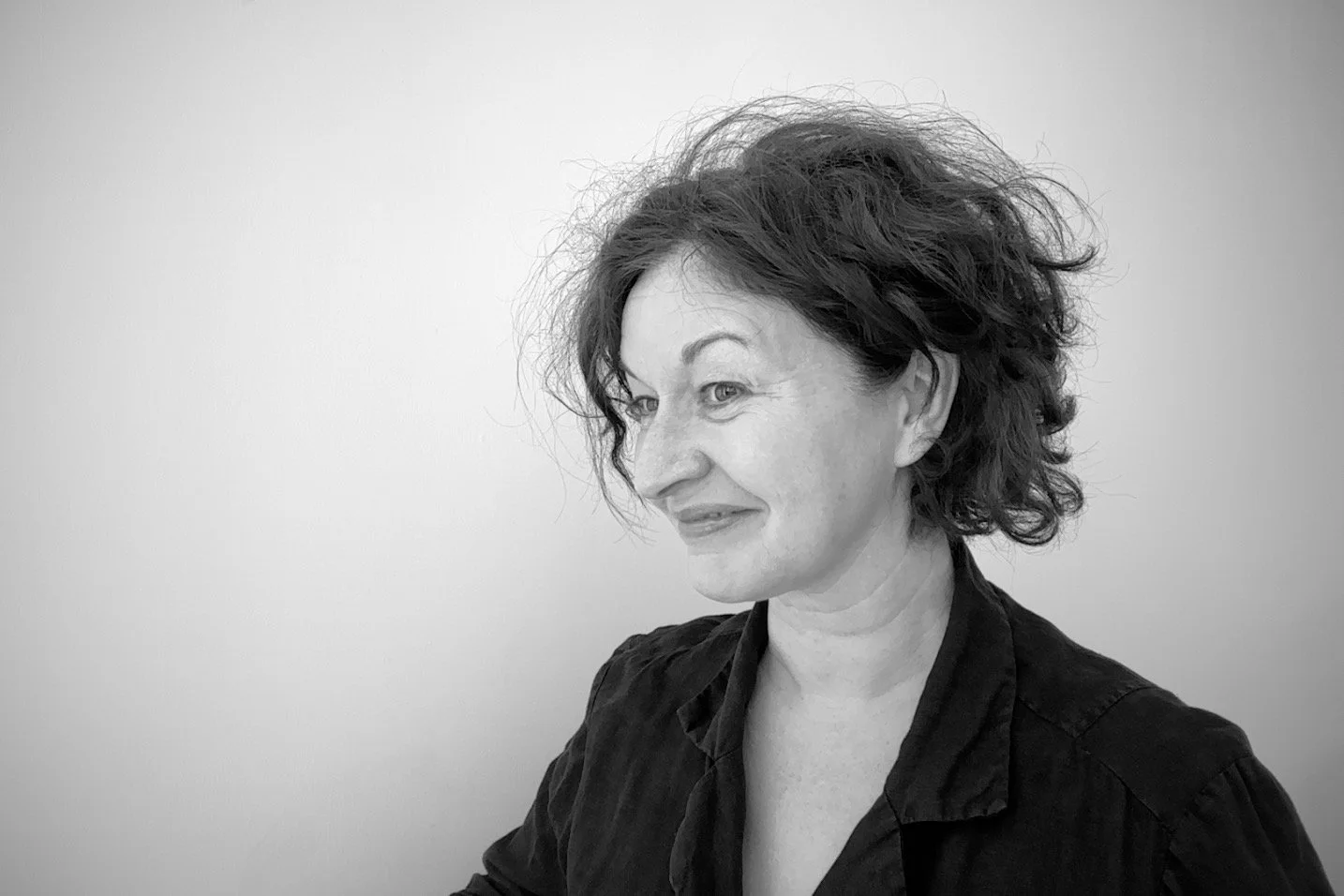 Black-and-white photograph of the head and shoulders of a woman in part-profile.