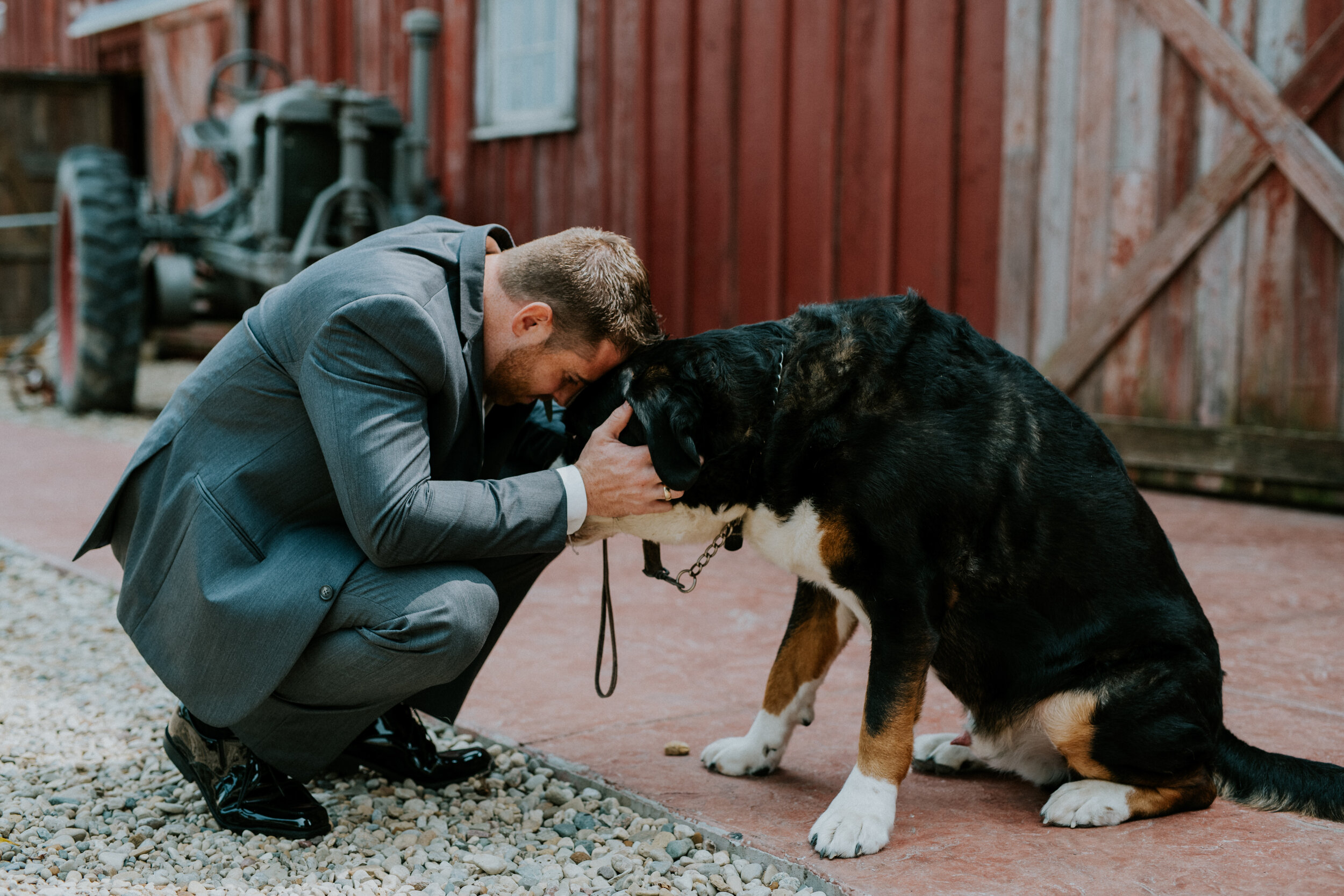 Groom in tuxedo with dog