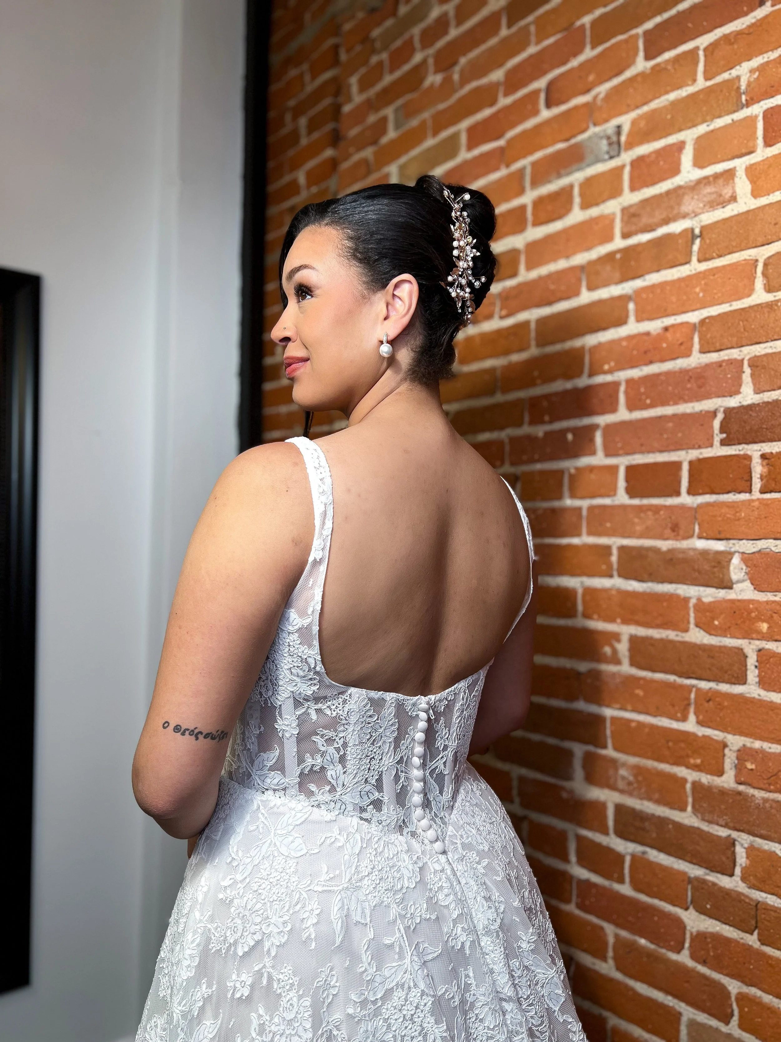 woman in dress with hairpiece and accessories on.