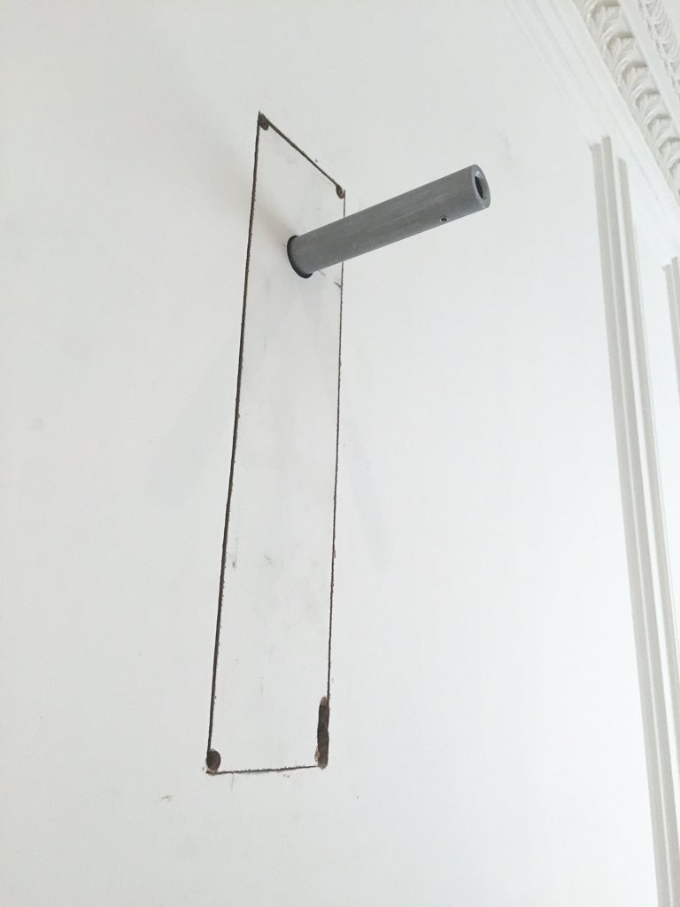 A piece of drywall is then fit over the mount, hiding the hanging hardware entirely.