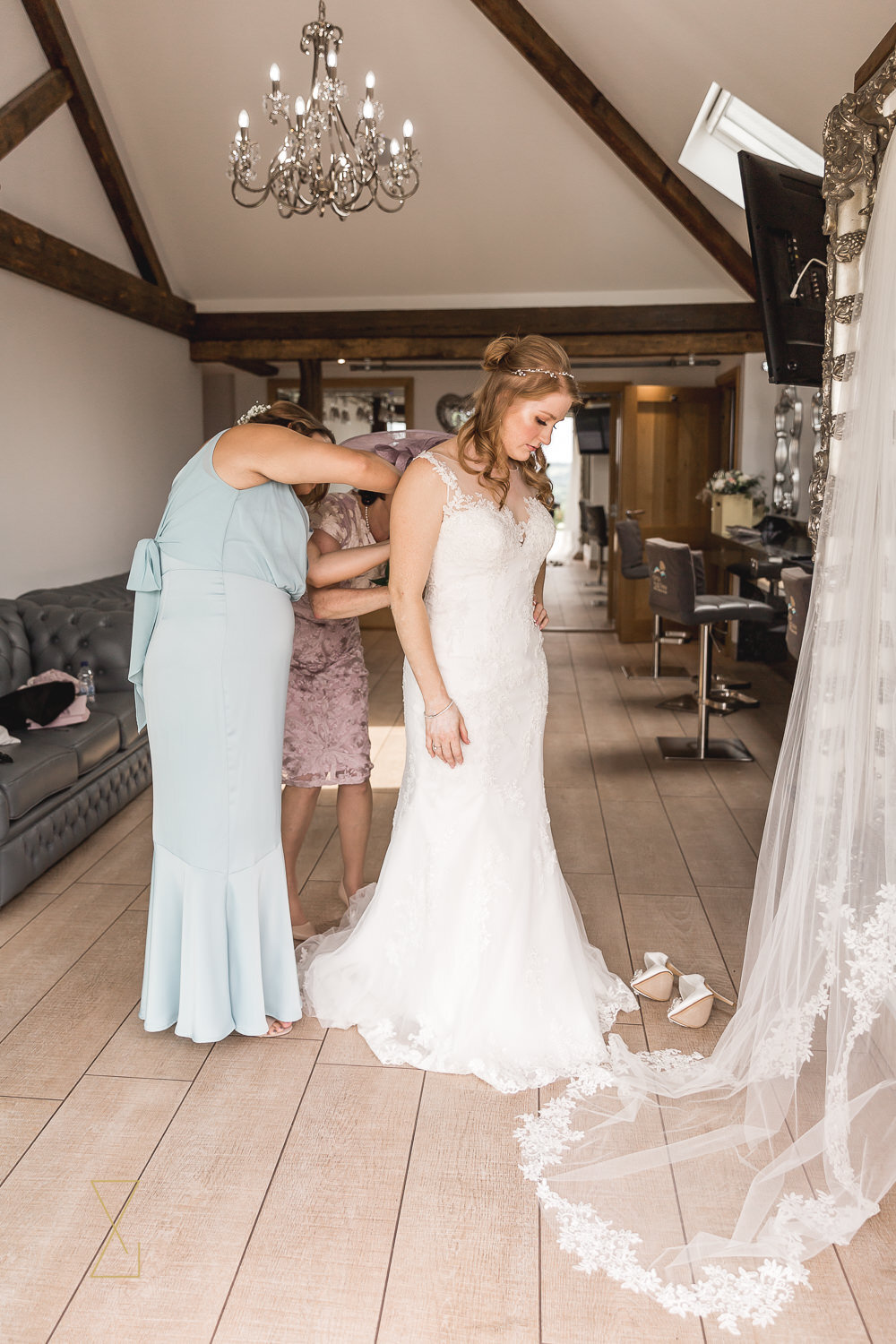 Bride-getting-into-wedding-dress-Cheshire-wedding