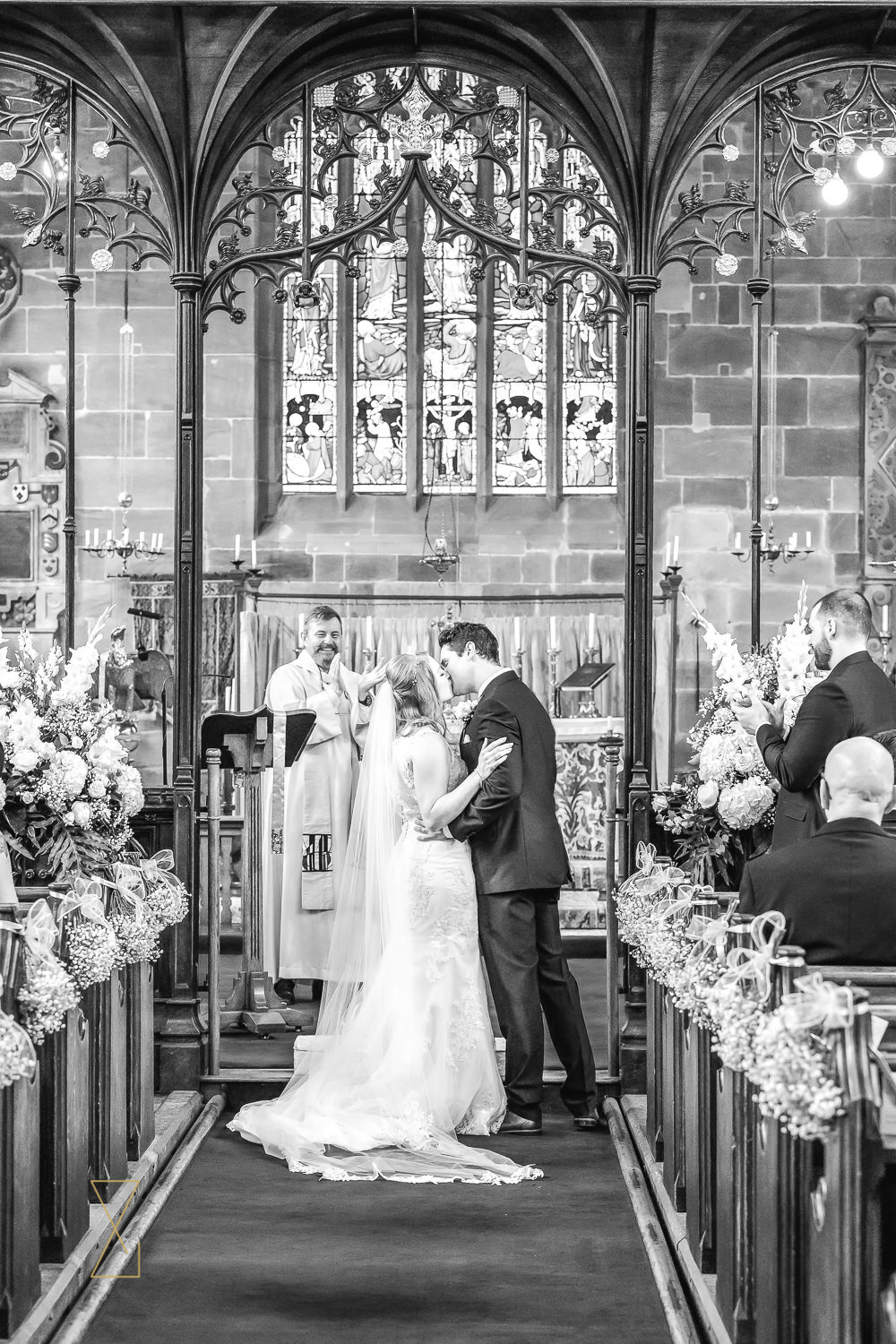 Bride-and-groom-kiss-Gawsworth-church
