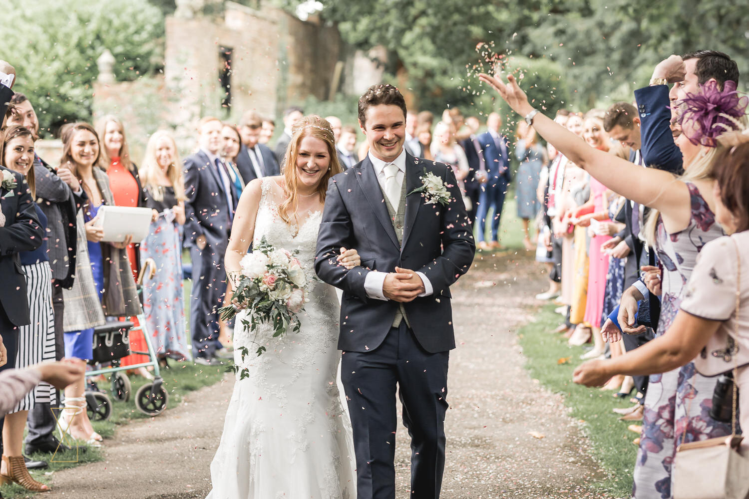 Bride-and-groom-covered-in-confetti-St-James-Gawsworth-wedding