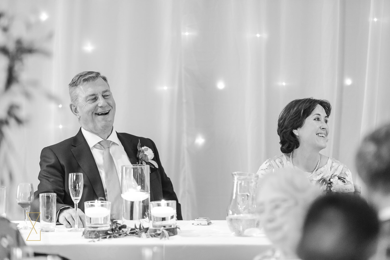 Father-of-the-bride-laughing-at-wedding-speech