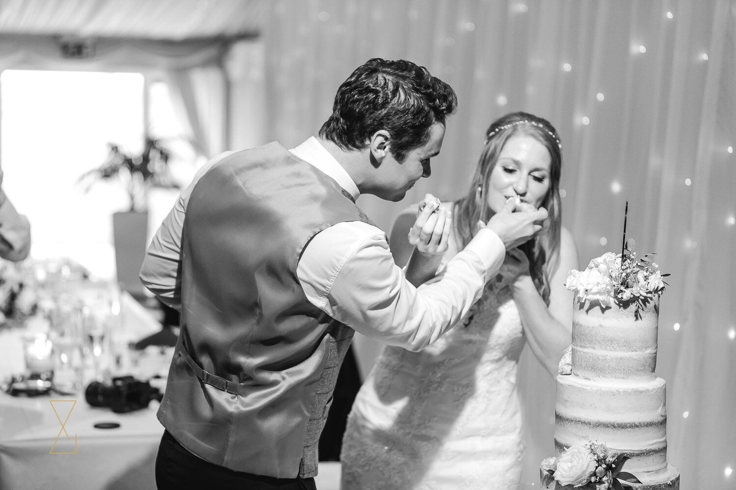 Groom-feeds-bride-wedding-cake