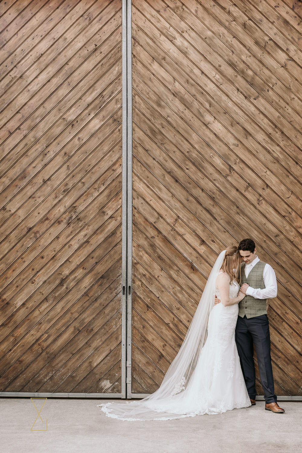 Bride-and-groom-by-the-barn-Heaton-House-Farm