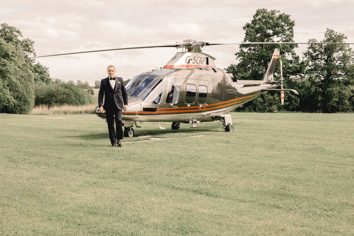 Groom-walking-from-helicopter-Rookery-Hall-wedding