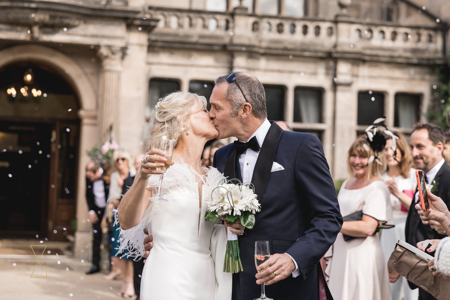 Bride-and-groom-kiss-outside-Rookery-Hall-Cheshire