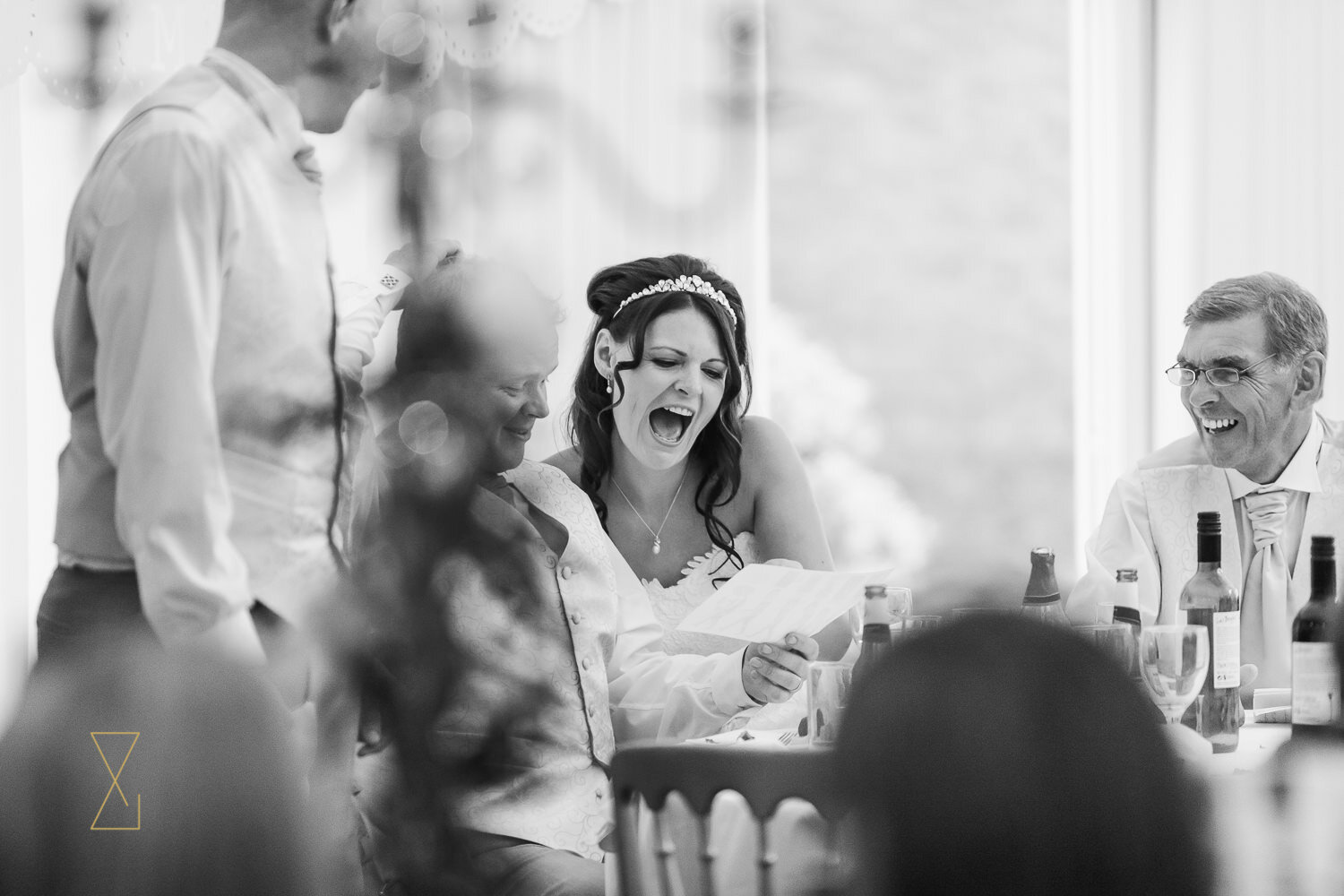 Bride-laughs-at-wedding-speech-Capesthorne-Hall