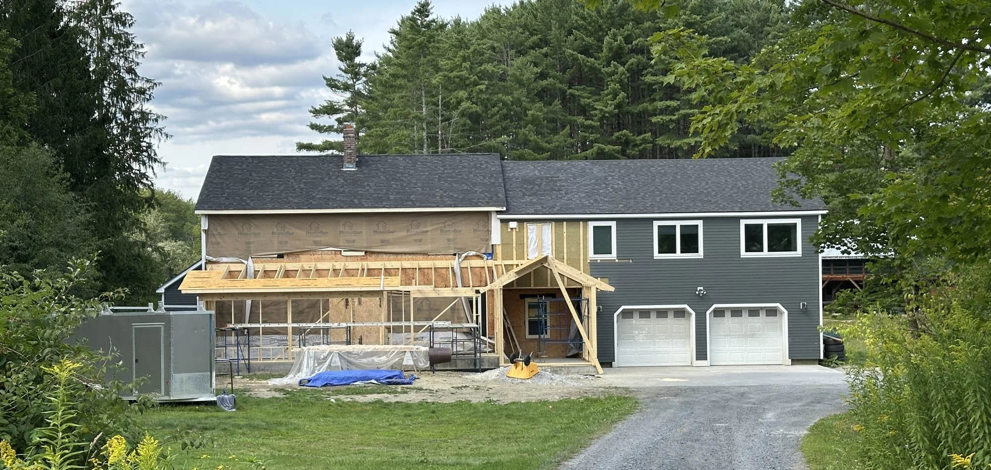 Front overall view showing porch and entry wood framing in progress. Designed by Arocordis.