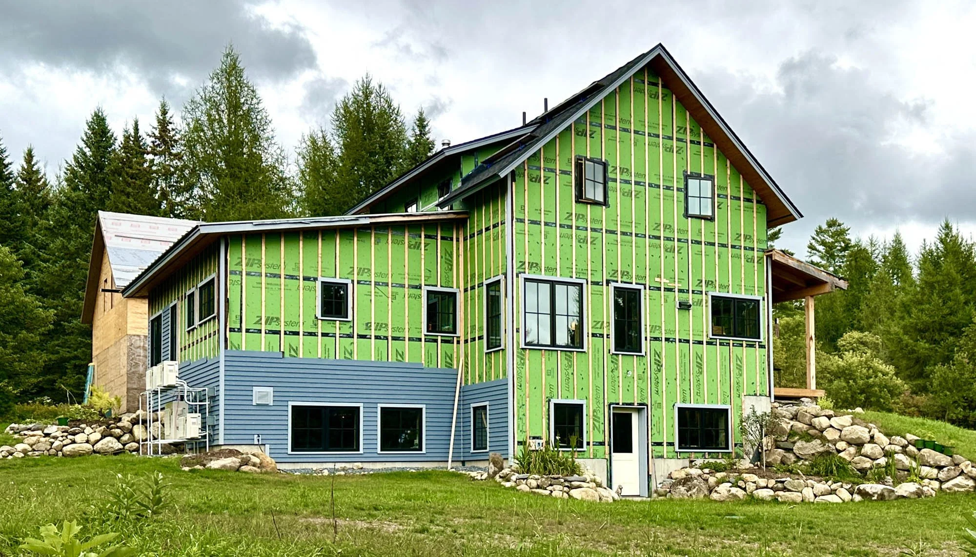 Under construction view of an Arocordis Design 3-bedroom all-electric home in Burke, Hollow Vermont. Three levels of living space with rustic modern-farmhouse lines.