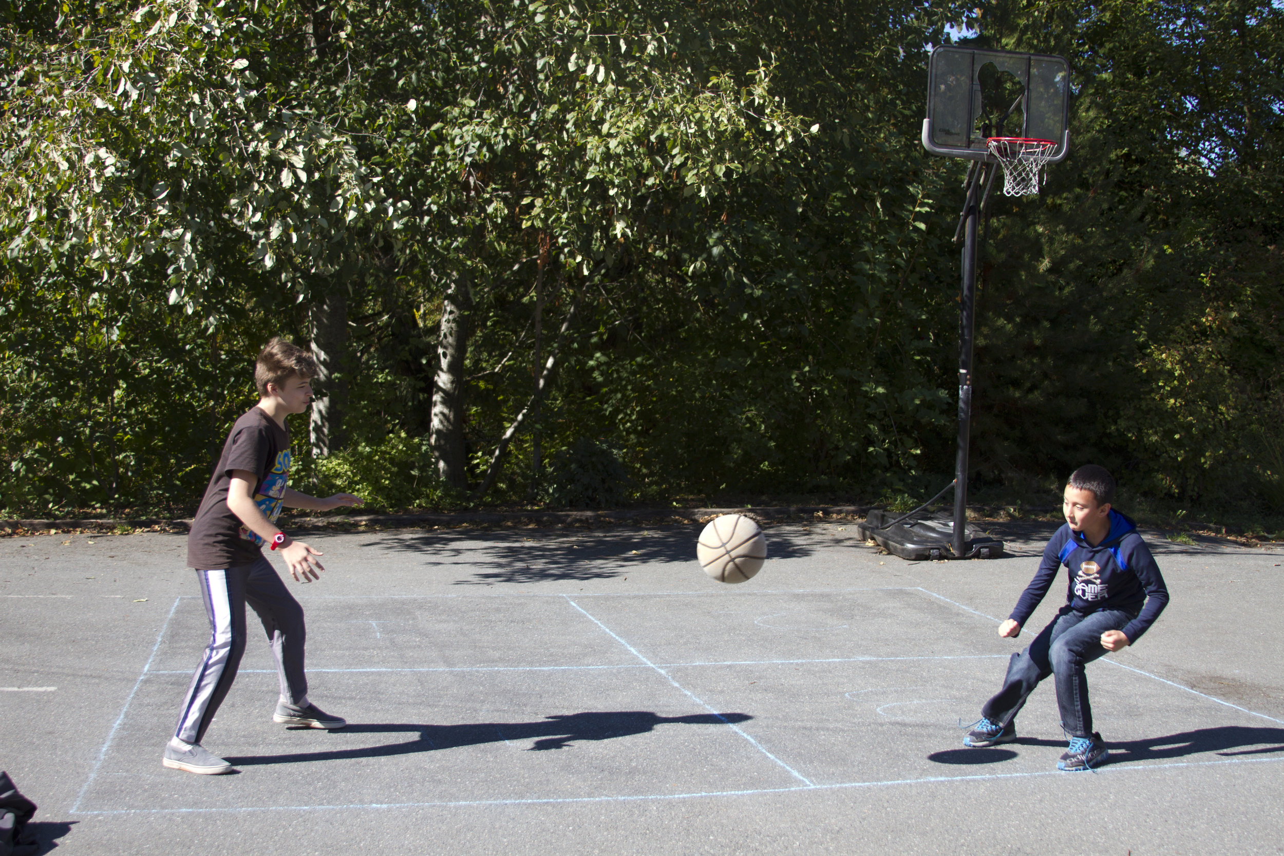 Two students playing on a Foursquare court.