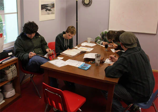 Students studying in the kitchen.
