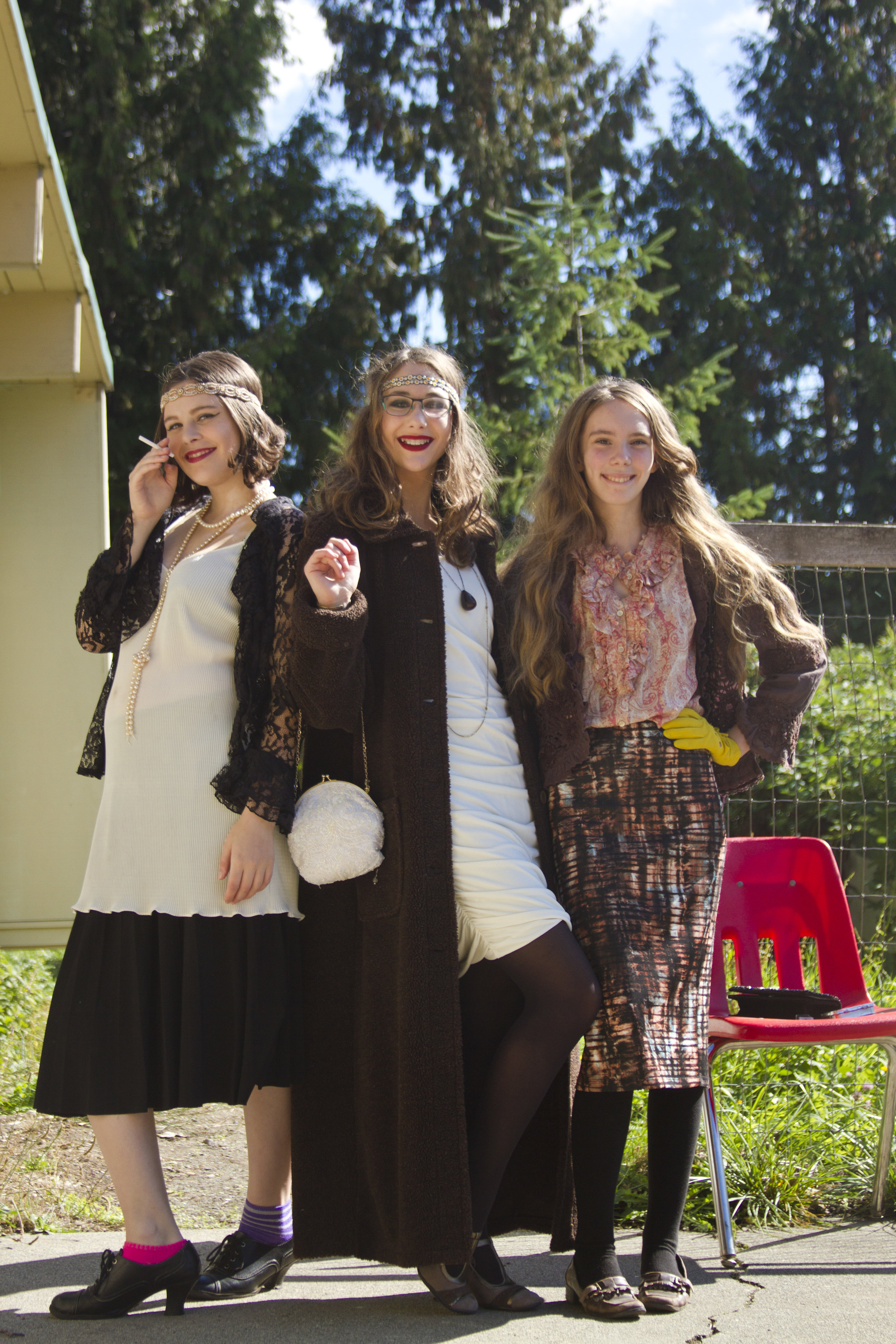 Three students pose for the camera. They are dressed in costume for their Live Action Roleplaying Game.
