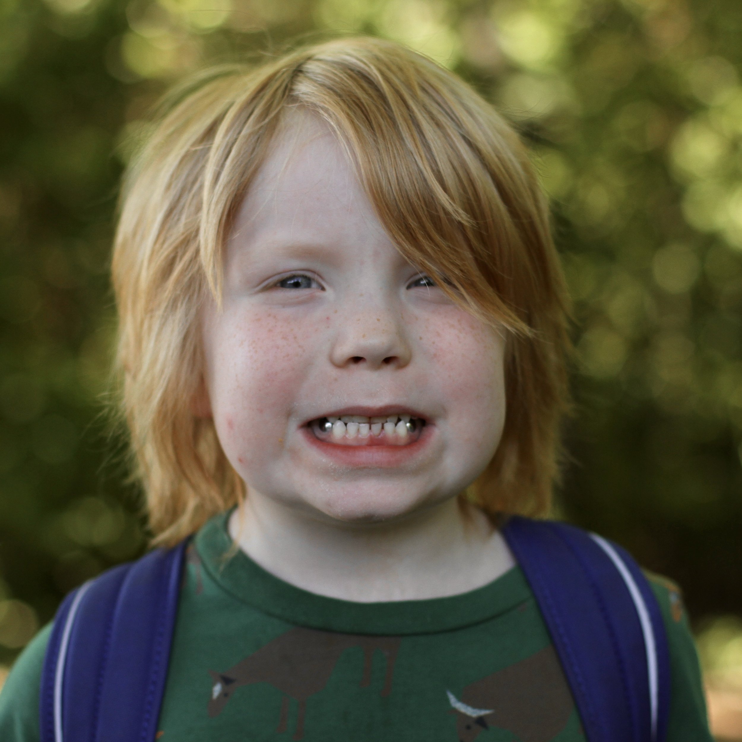 Young student grinning with medium blond hair