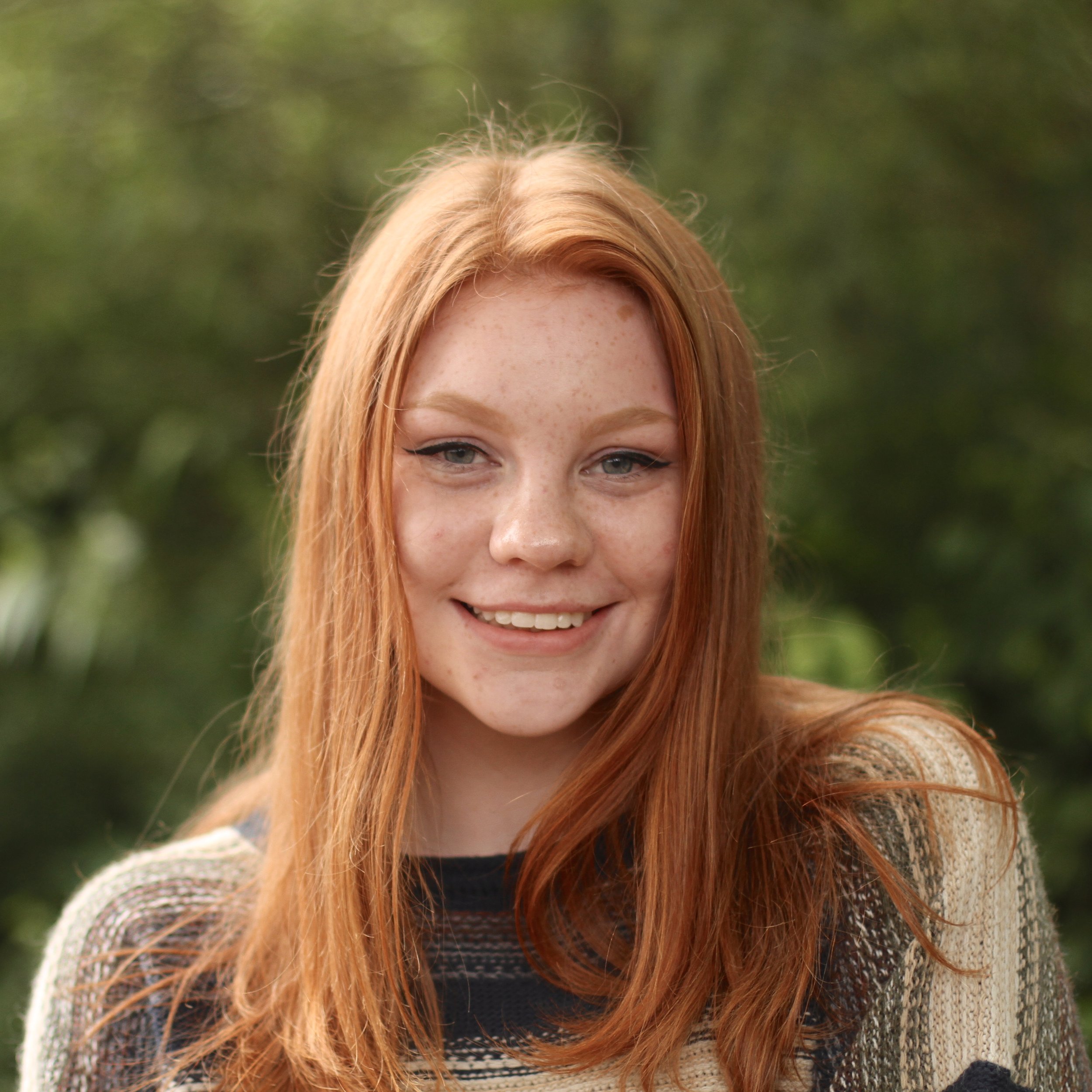 Teenage student smiling with long red hair