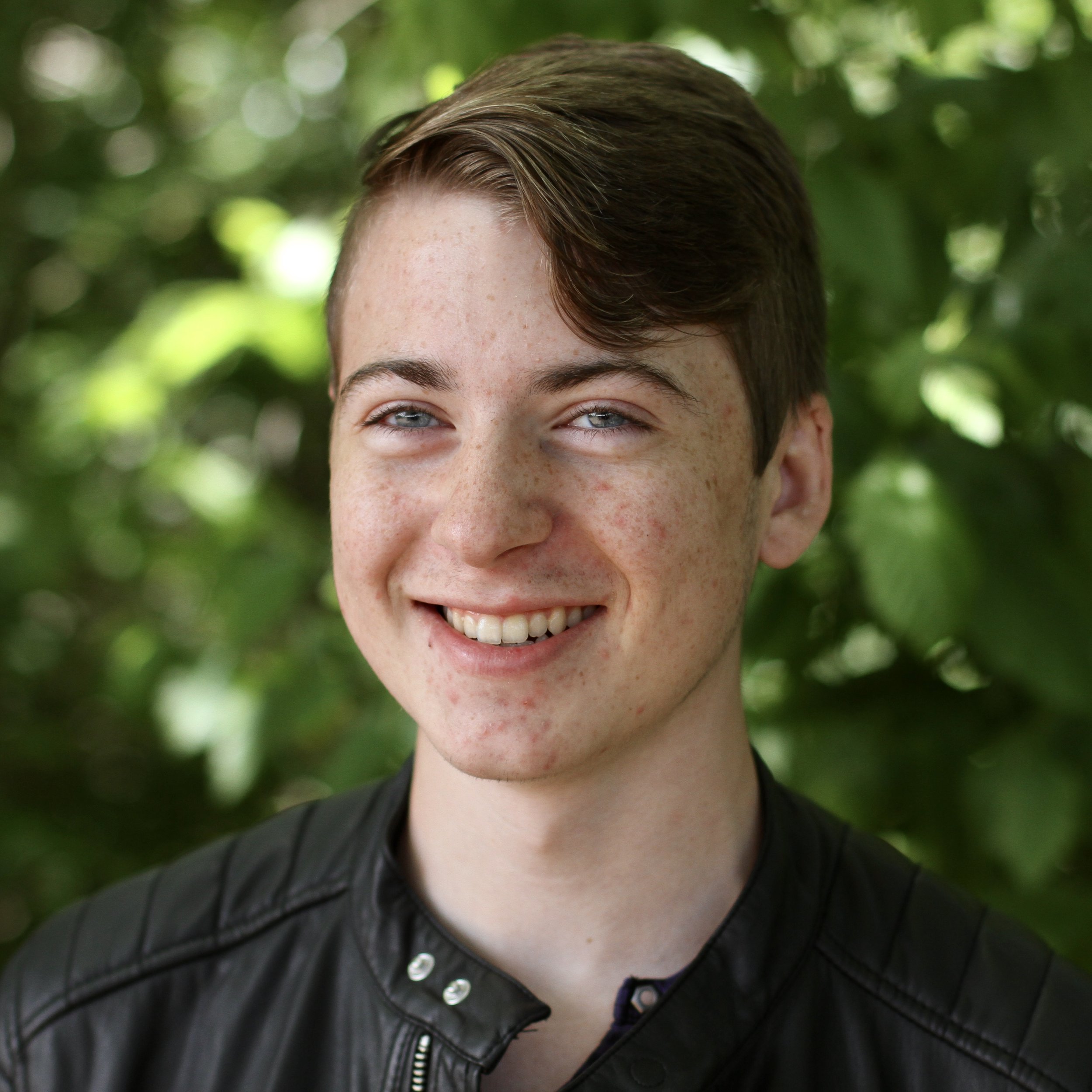 Teenage student smiling with short brown hair