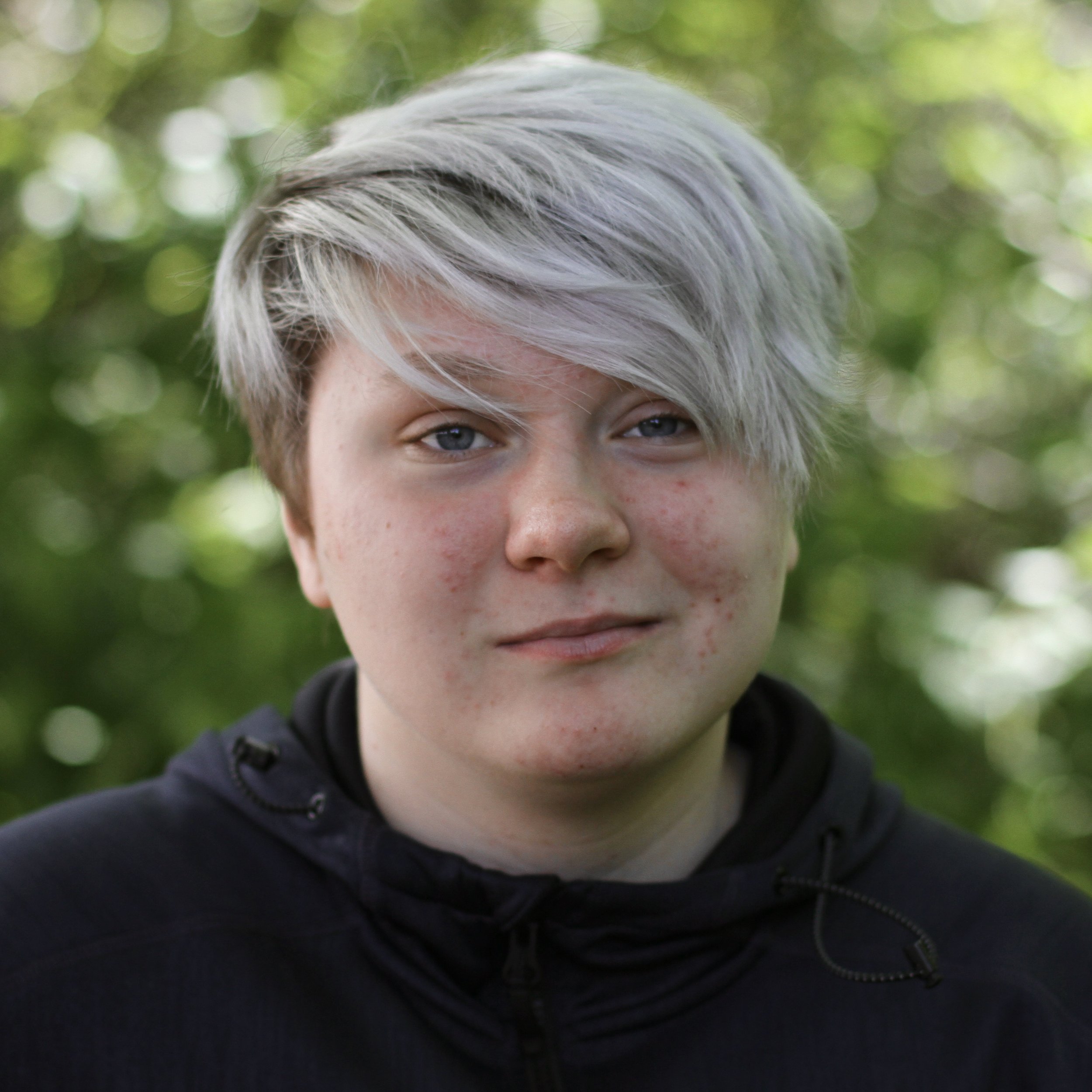 Teenage student with short white hair