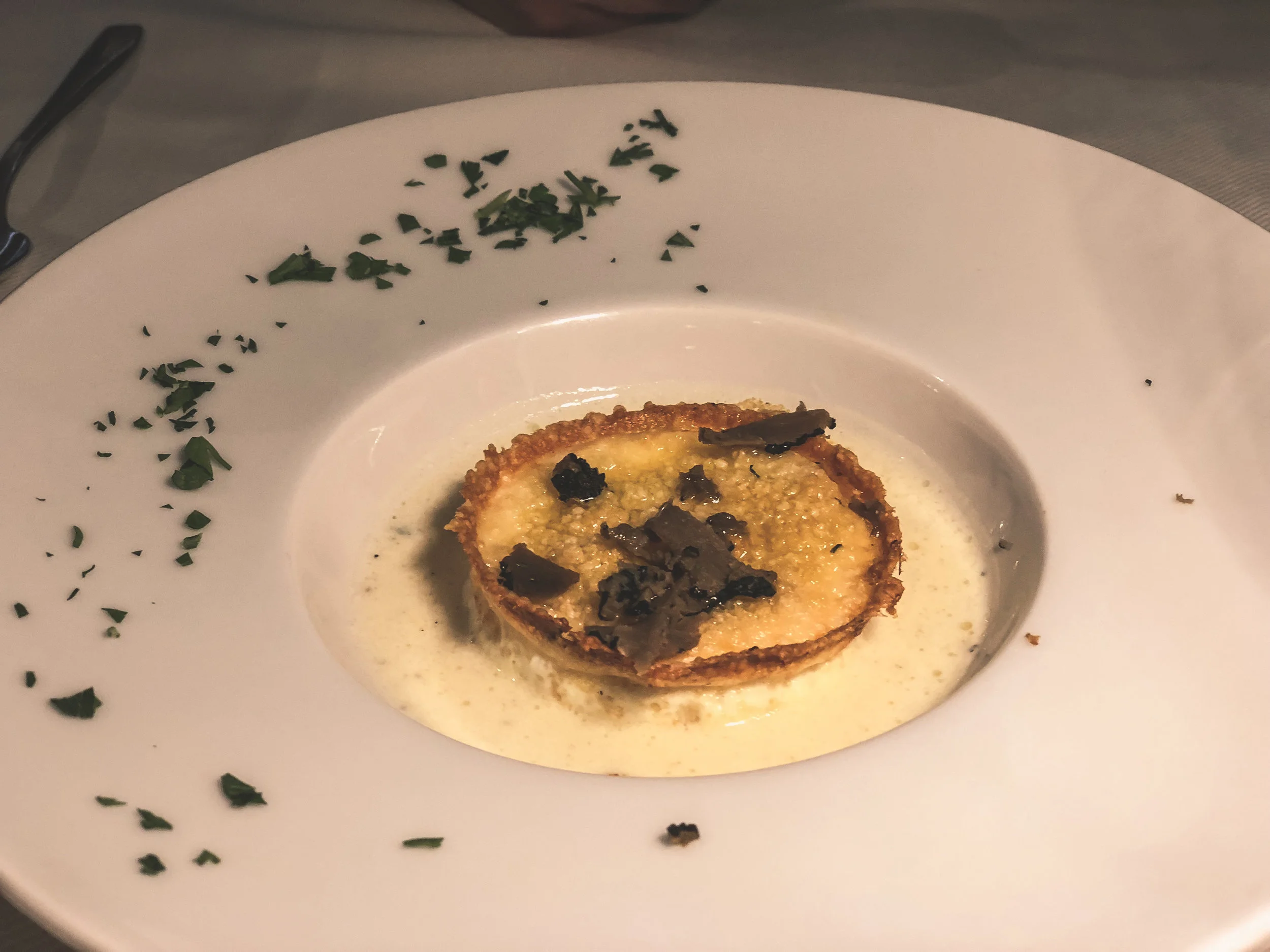 egg in parmesan crust with fresh truffles AT OSTERIA OTTAVIUS, BEVAGNA