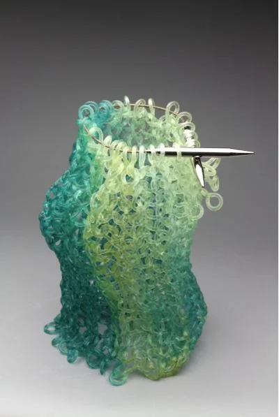 Carol Milne, Wiggle Room , 2017, kiln cast lead crystal and Addi click knitting needles, 14h x 10w x 10 d inches, Courtesy of the Artist