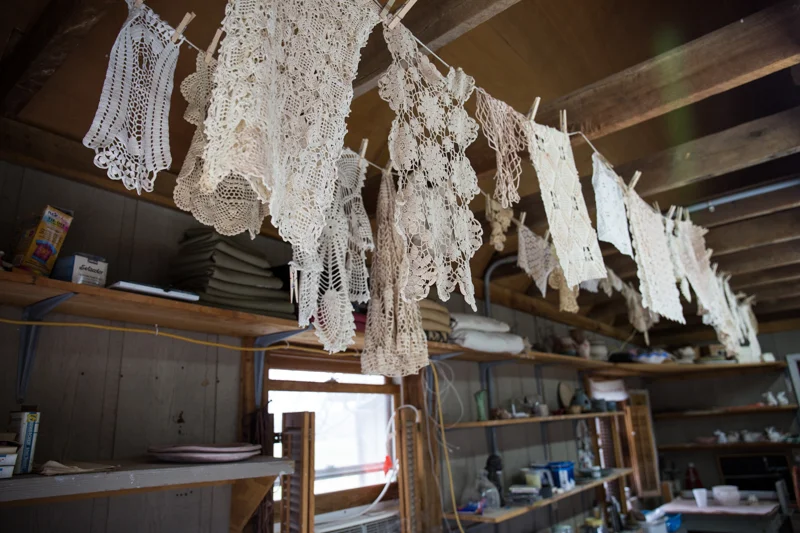 Crocheted doilies hanging at Ewell Farm Studio ready to be pressed into clay.