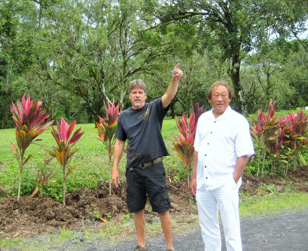 Workplace Readiness Program Director John Theismann points to orchard features with school Director Steve Hirakami
