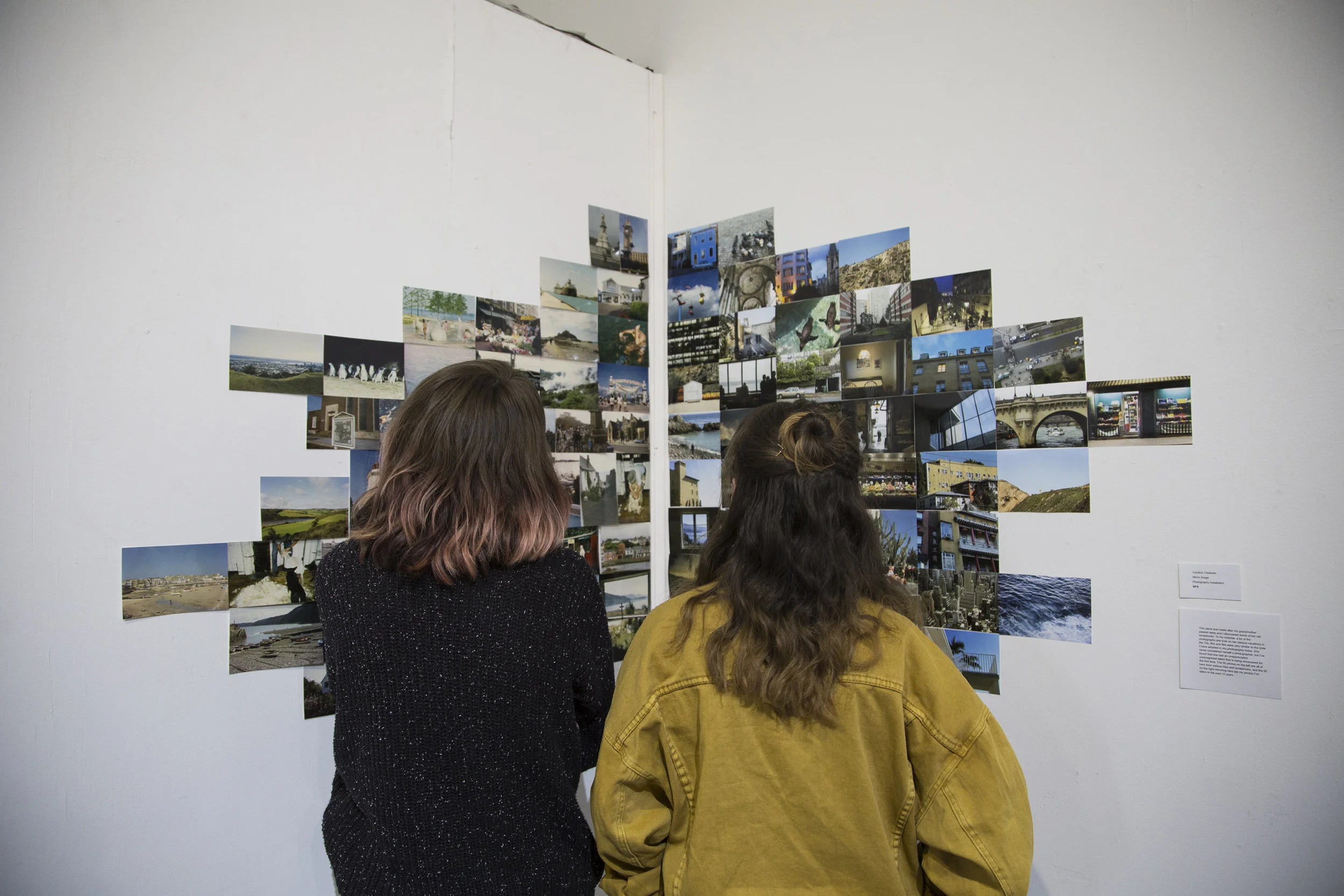 Guests viewing installation photography by Caroline Chidester -- Photo by Caroline Chidester