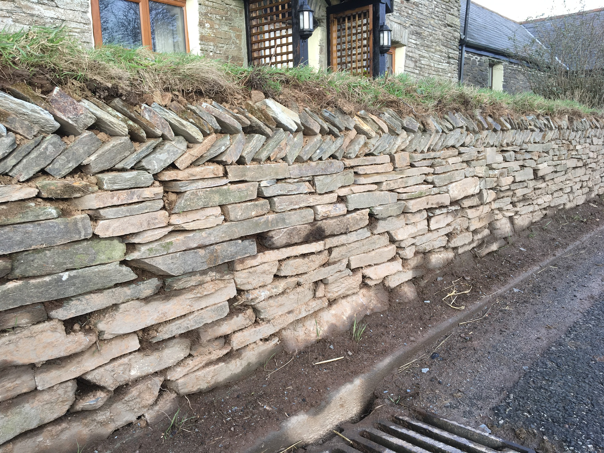 Slate wall with herringbone top.