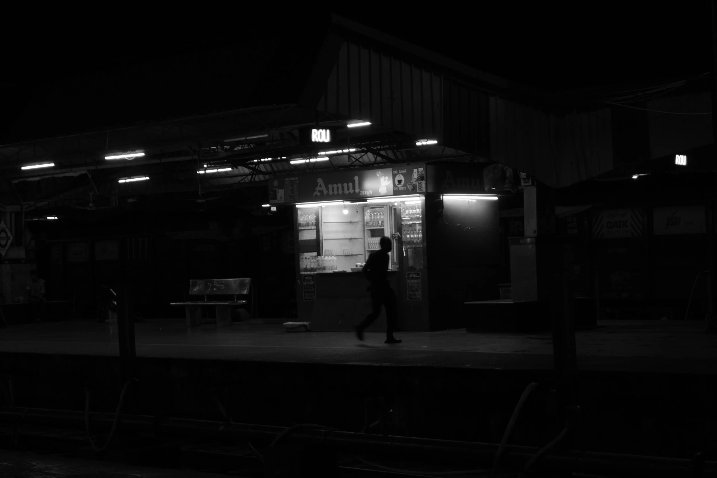 a lone figure against a dark cityscape