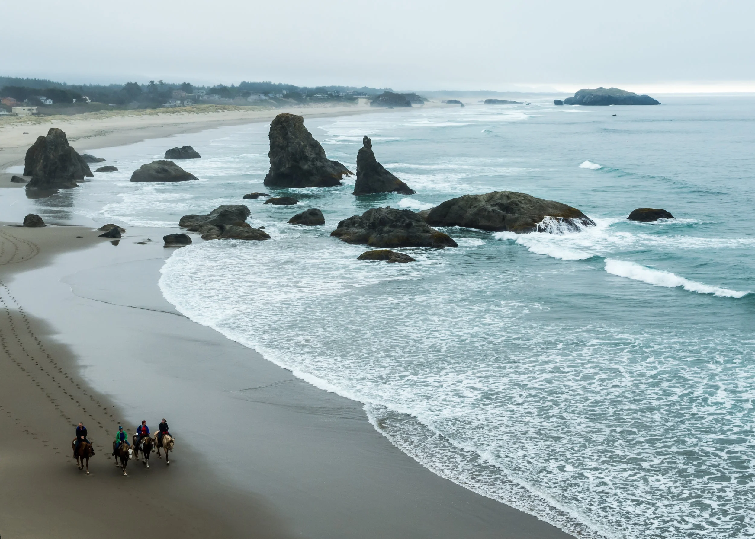 Horseback riders in BANDON, OREGON. ADOBE STOCK PHOTO.