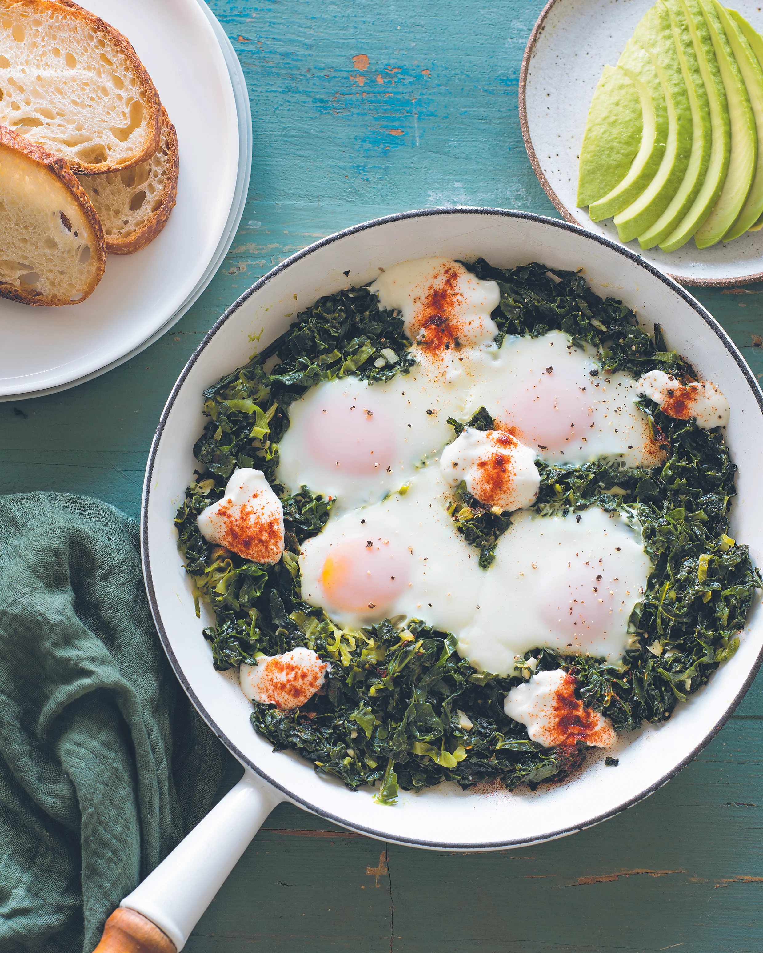 Baked eggs with greens, avocado and yoghurt