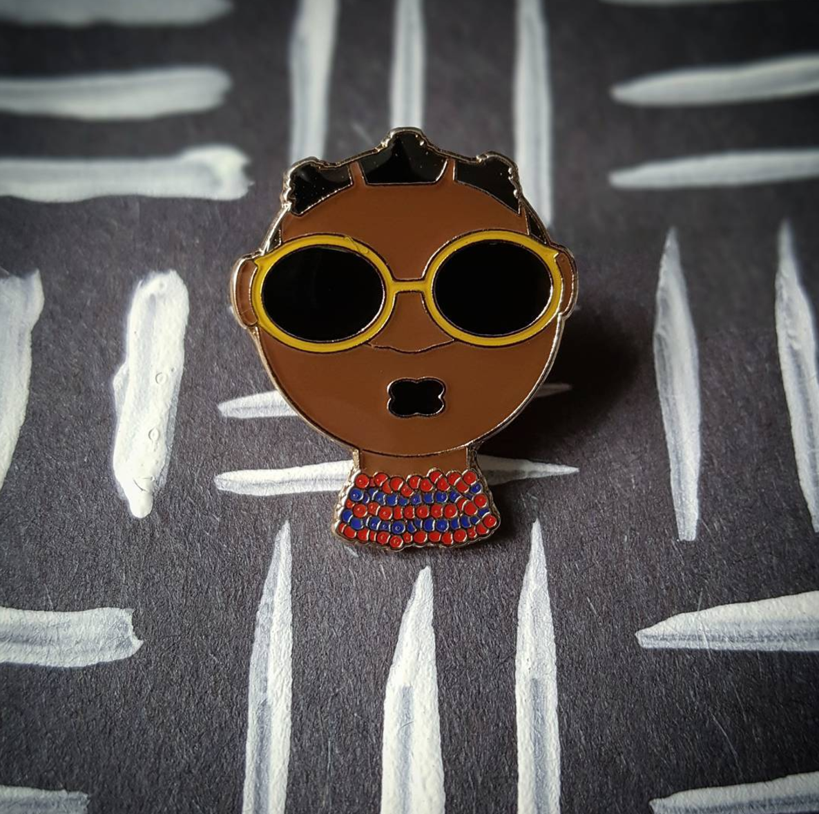 “Respiration” pin designed by Jermaine Bell.